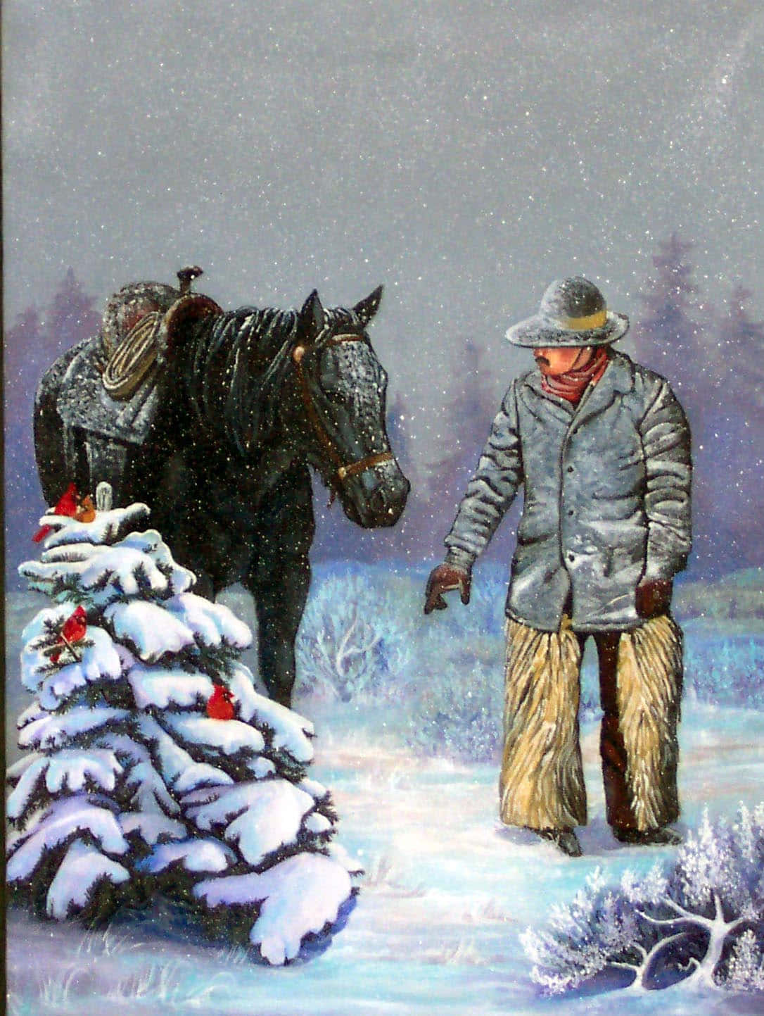 Cowboy Christmas 桌布 壁紙 — 一名牛仔在暴風雪中站在他的黑馬旁邊，靠近一棵積雪的松樹，樹上有紅衣主教鳥。