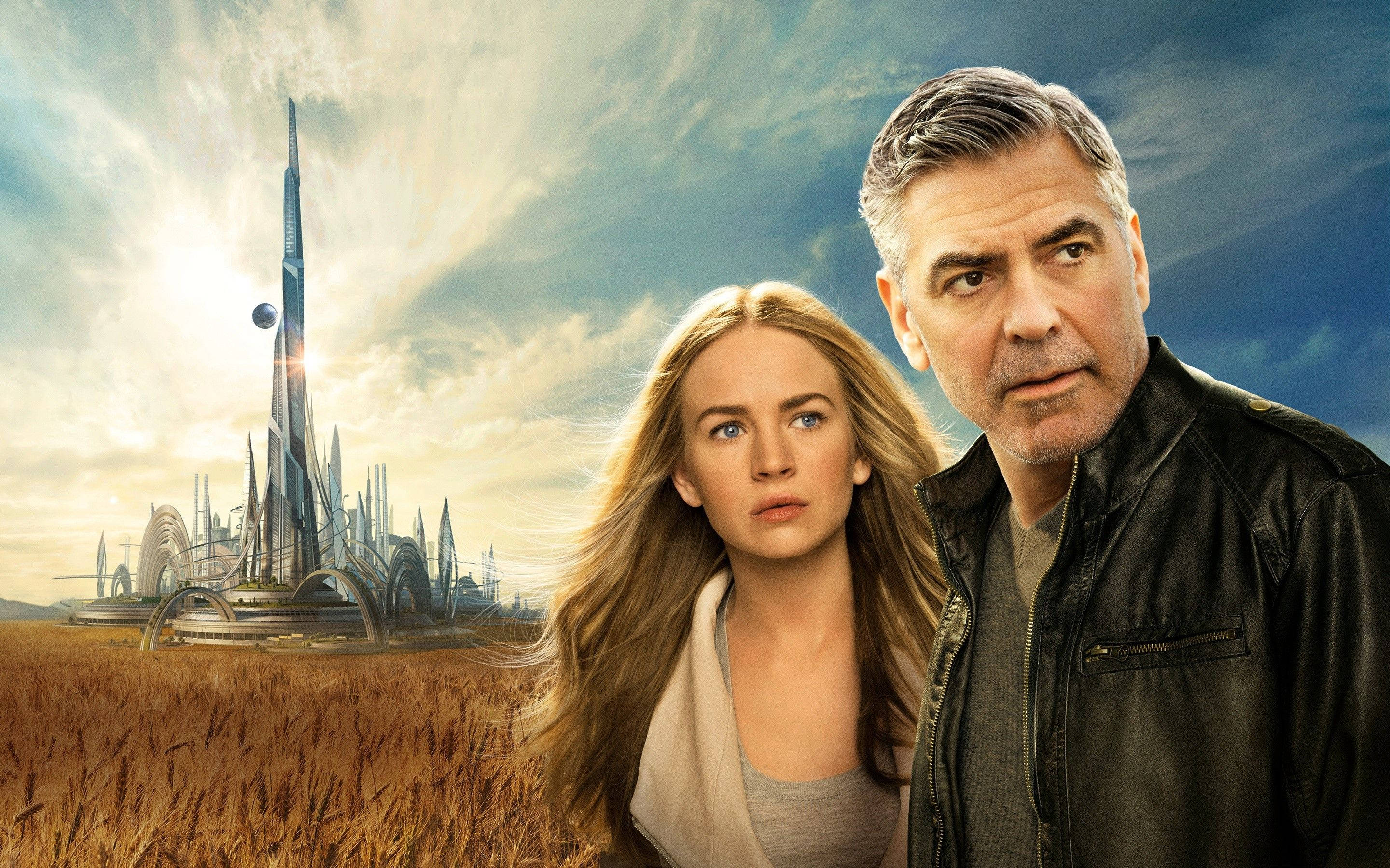 Tomorrowland Movie 桌布 壁紙 — 一名男子和女子站在金色田野中，面前是宏偉的未來城市，天空明亮，有一個漂浮的球體。