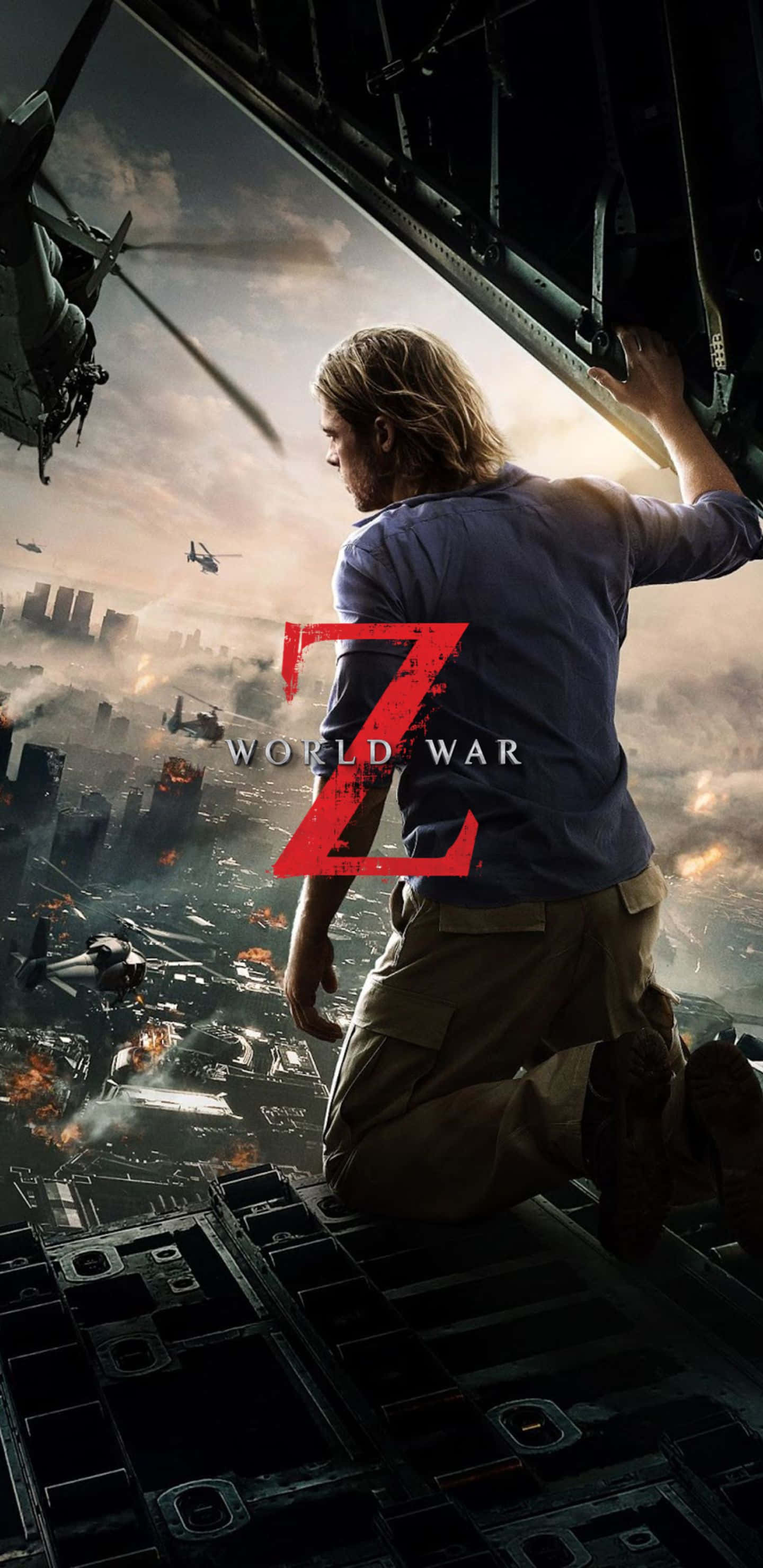 Pixel 3xl World War Z 桌布 壁紙 — 一名男子跪在直升機邊緣，俯瞰被殭屍直升機和爆炸蹂躪的城市。