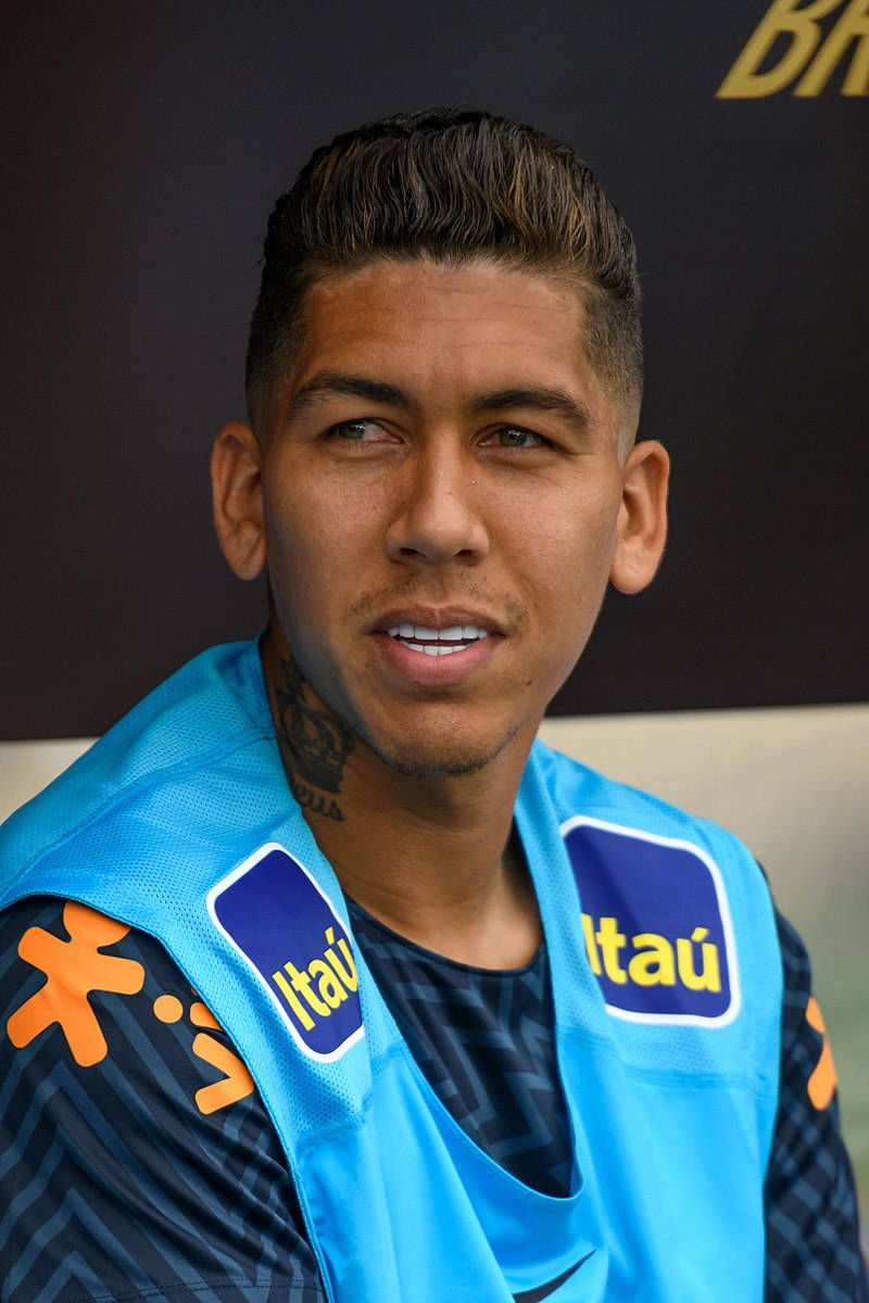 Football Players 桌布 壁紙 — 一名男性足球員的近距離肖像，身穿亮藍色訓練背心，上面有 Itaú 贊助商標誌，內搭深色圖案球衣。