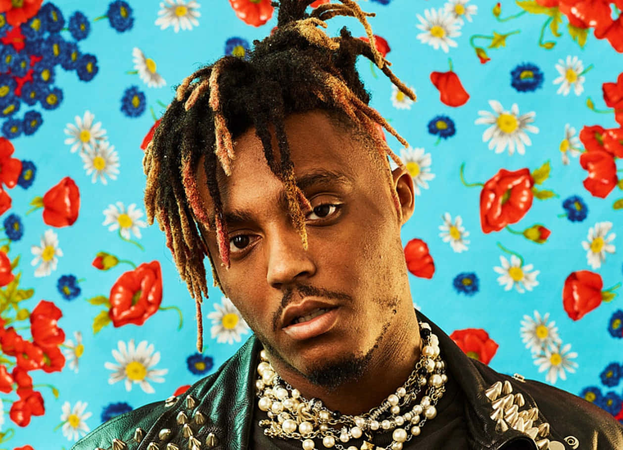 男子留著辮子頭、戴著珍珠項鍊，背景為花卉。 — Juice Wrld 壁紙