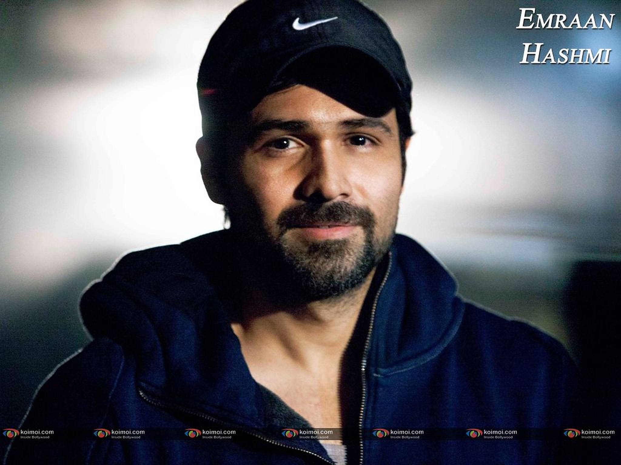 Emraan Hashmi 桌布 壁紙 — 一名留鬍鬚戴帽子的男子在柔和的工作室燈光下直視鏡頭。