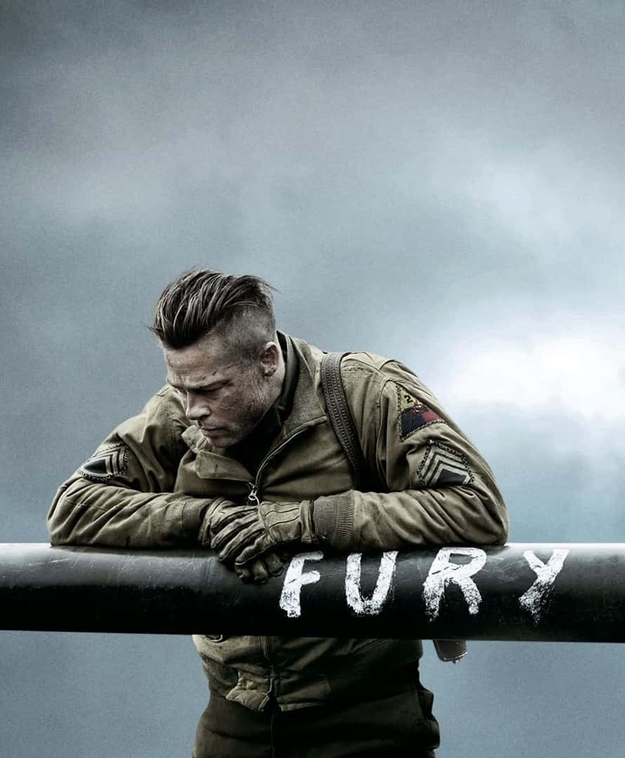 Ww2 iPhone 桌布 壁紙 — 一名疲憊的士兵穿著軍用夾克，沉重地靠在一根標有'FURY'的坦克炮管上，背景是陰沉的陰天。