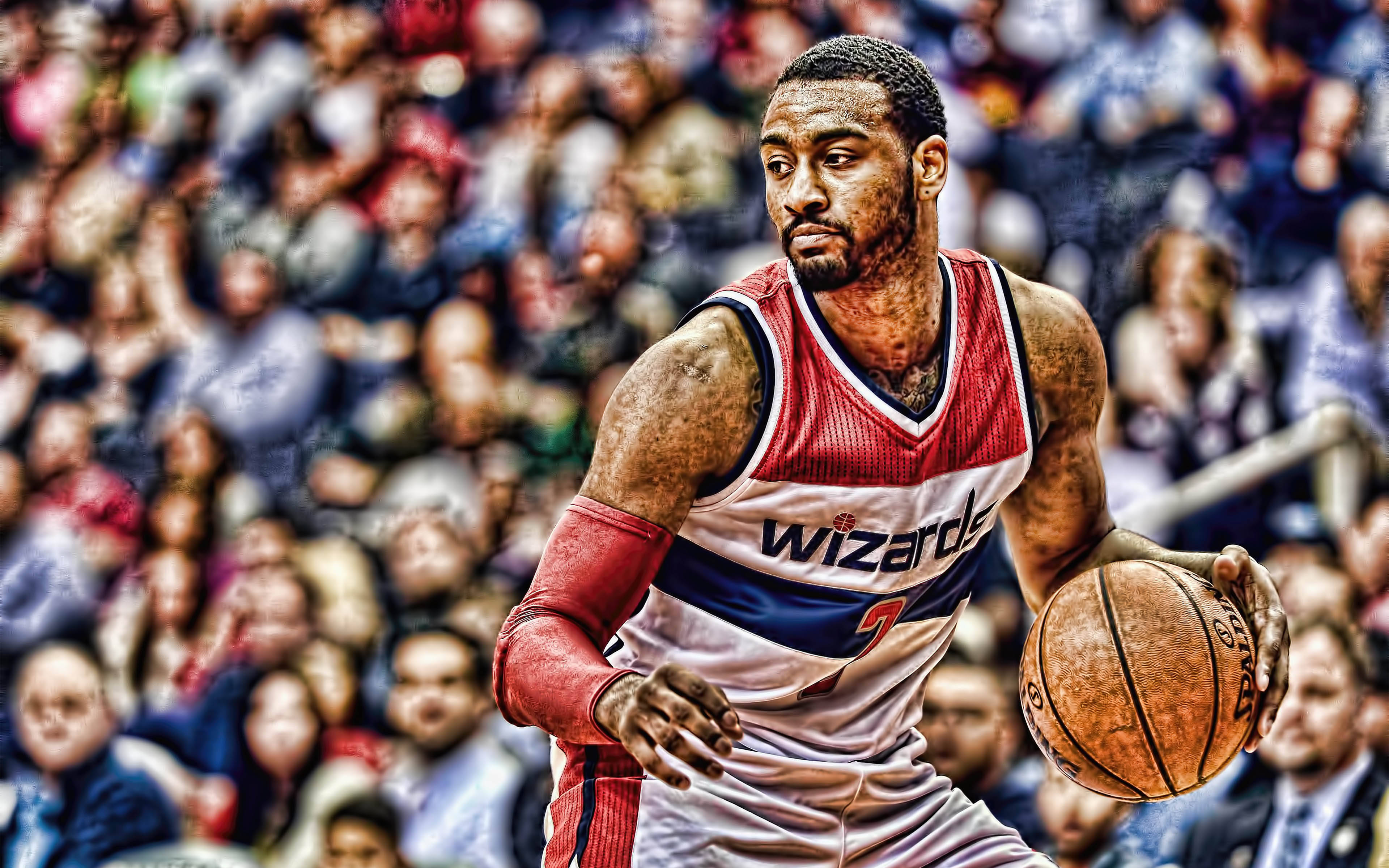 John Wall 桌布 壁紙 — 一名穿著巫師隊球衣的籃球運動員在比賽中激烈運球，背景是模糊的人群。