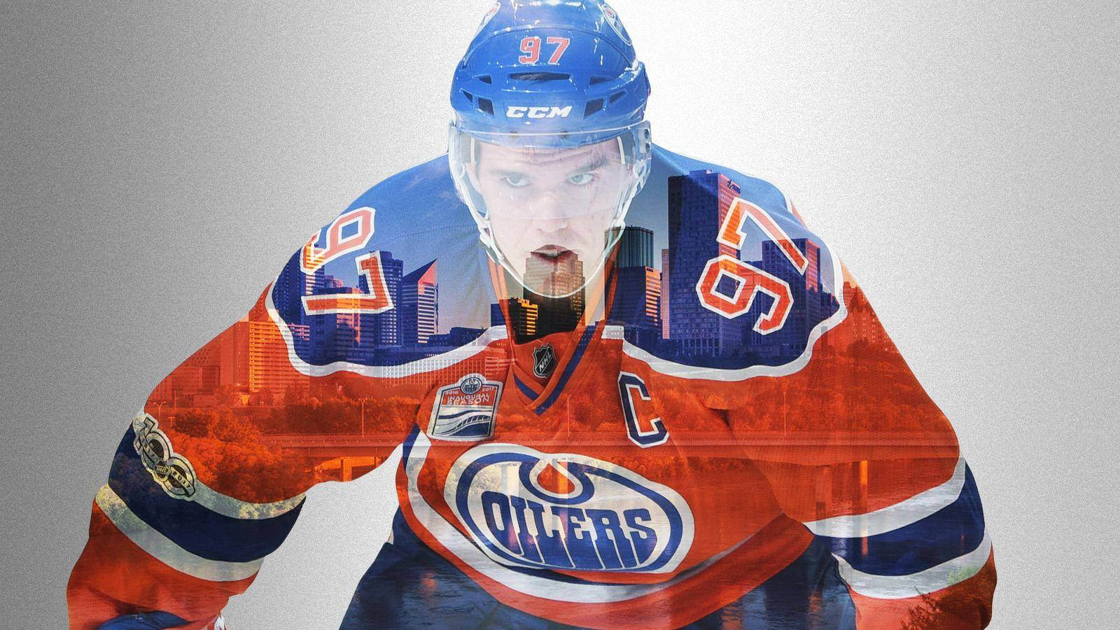 hockey 桌布 壁紙 — 一名穿著愛德蒙頓油人隊裝備的曲棍球運動員，他的球衣上疊加了城市天際線，背景為漸層色。