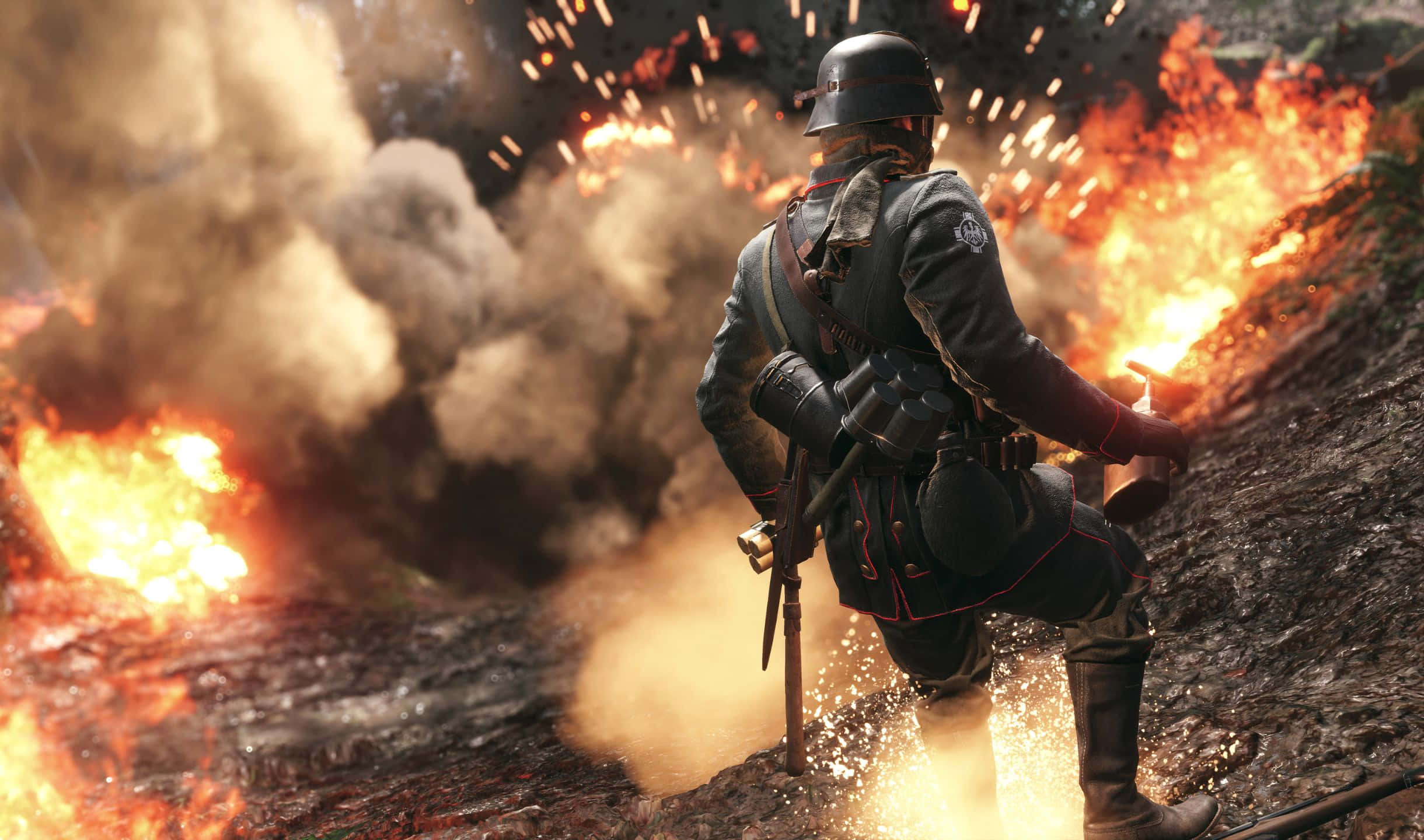 2440x1440 Battlefield 1 桌布 壁紙 — 一名穿著第一次世界大戰裝備的士兵在燃燒的戰場上前進，爆炸和煙霧在他周圍爆發。