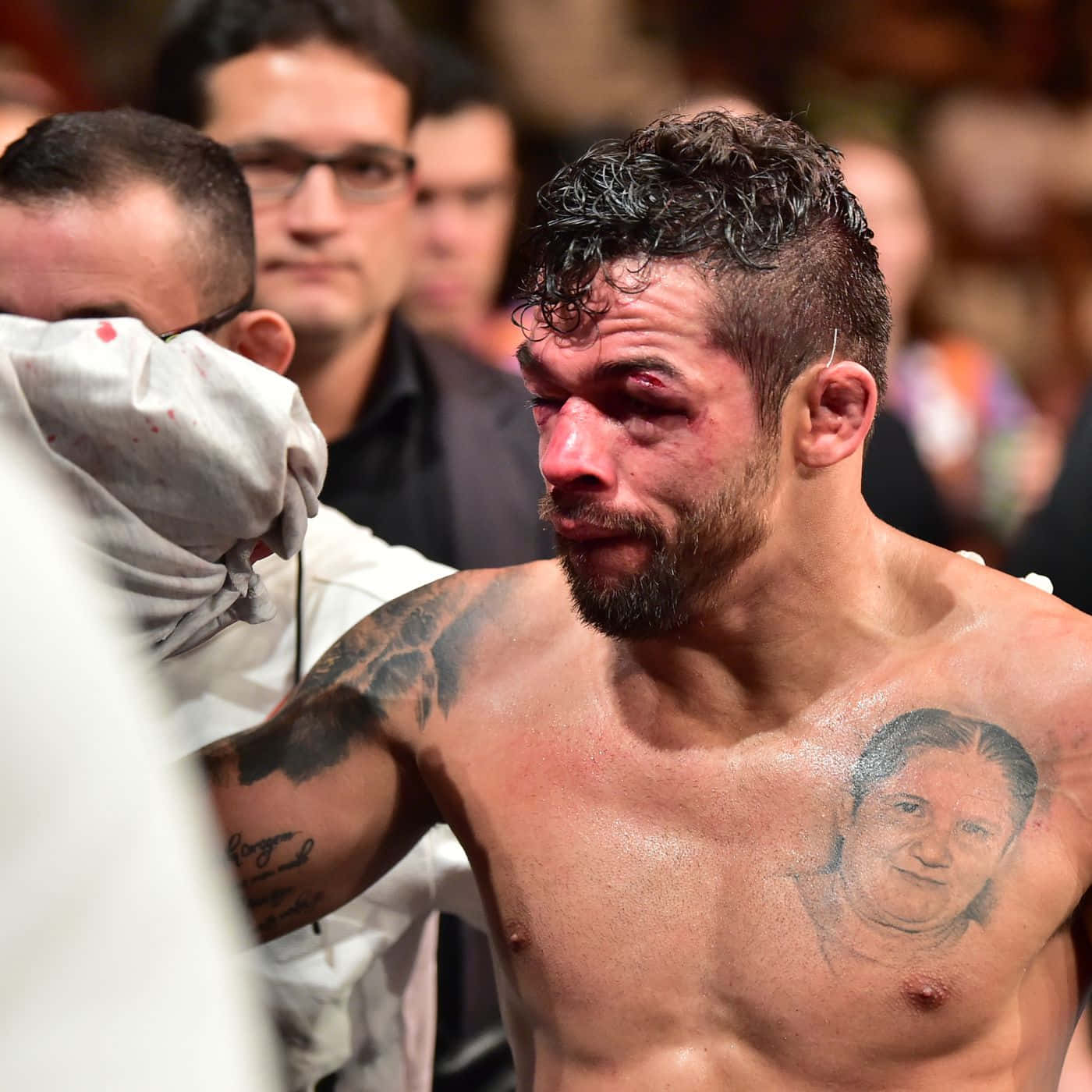 UFC 桌布 壁紙 — 一名胸口有女性刺青的血跡斑斑的戰士，在殘酷的比賽後低頭。