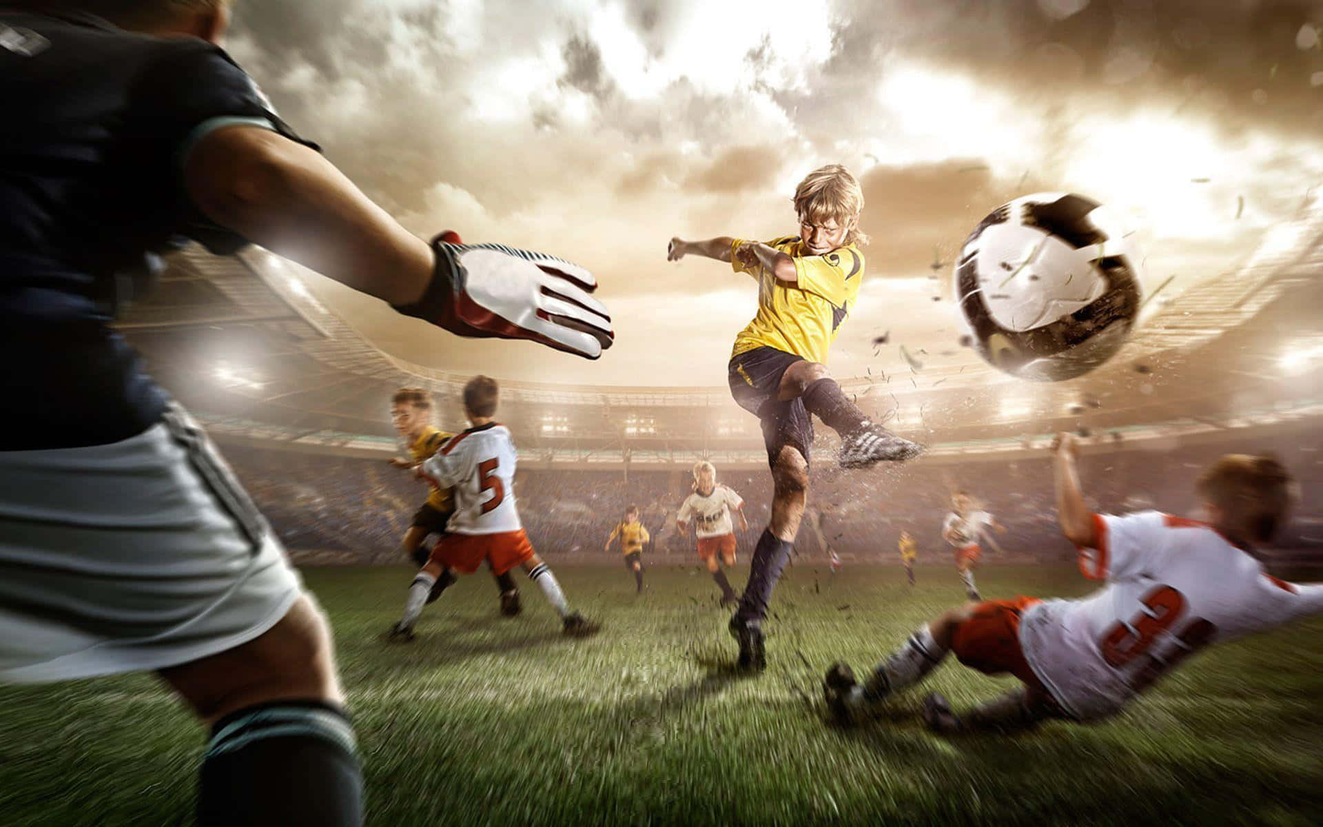 Football Players 桌布 壁紙 — 一名足球員跳起擊球，同時守門員飛撲，構成戲劇性的球場景觀。