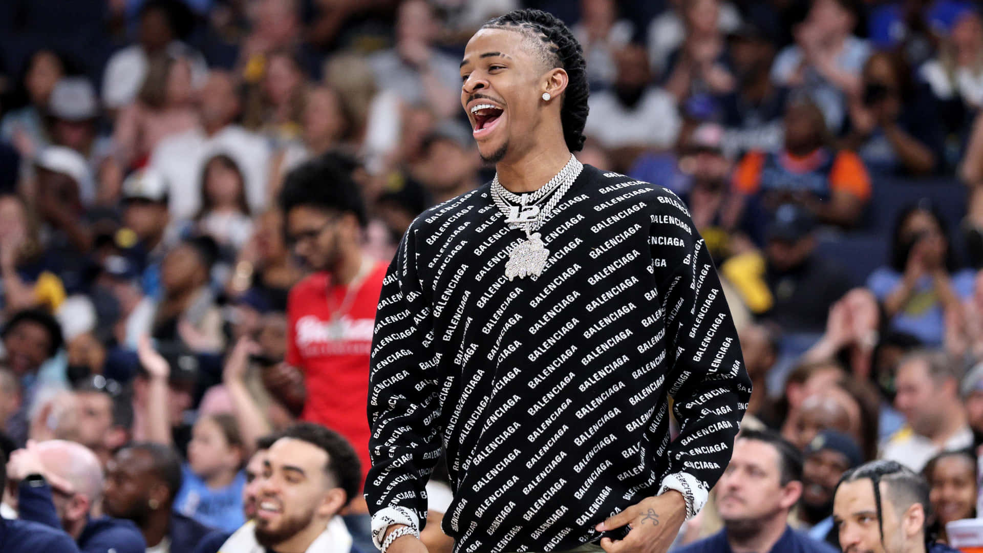Ja Morant 動圖 桌布 壁紙 — 一名身穿 Balenciaga 品牌球衣的籃球運動員在比賽中開懷大笑，身後是模糊的人群。