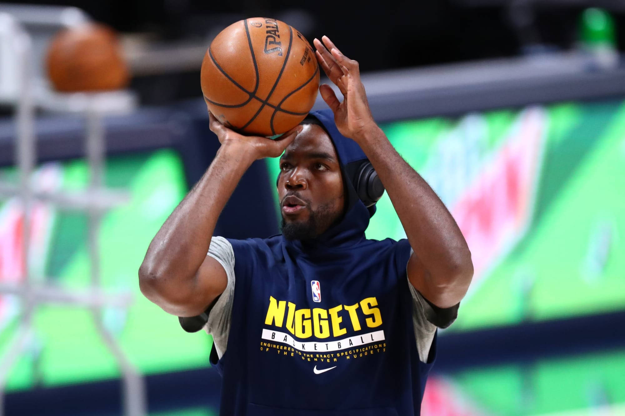 paul millsap 桌布 壁紙 — 一名身穿丹佛金塊隊連帽衫的籃球運動員在明亮的場館燈光下準備投籃。