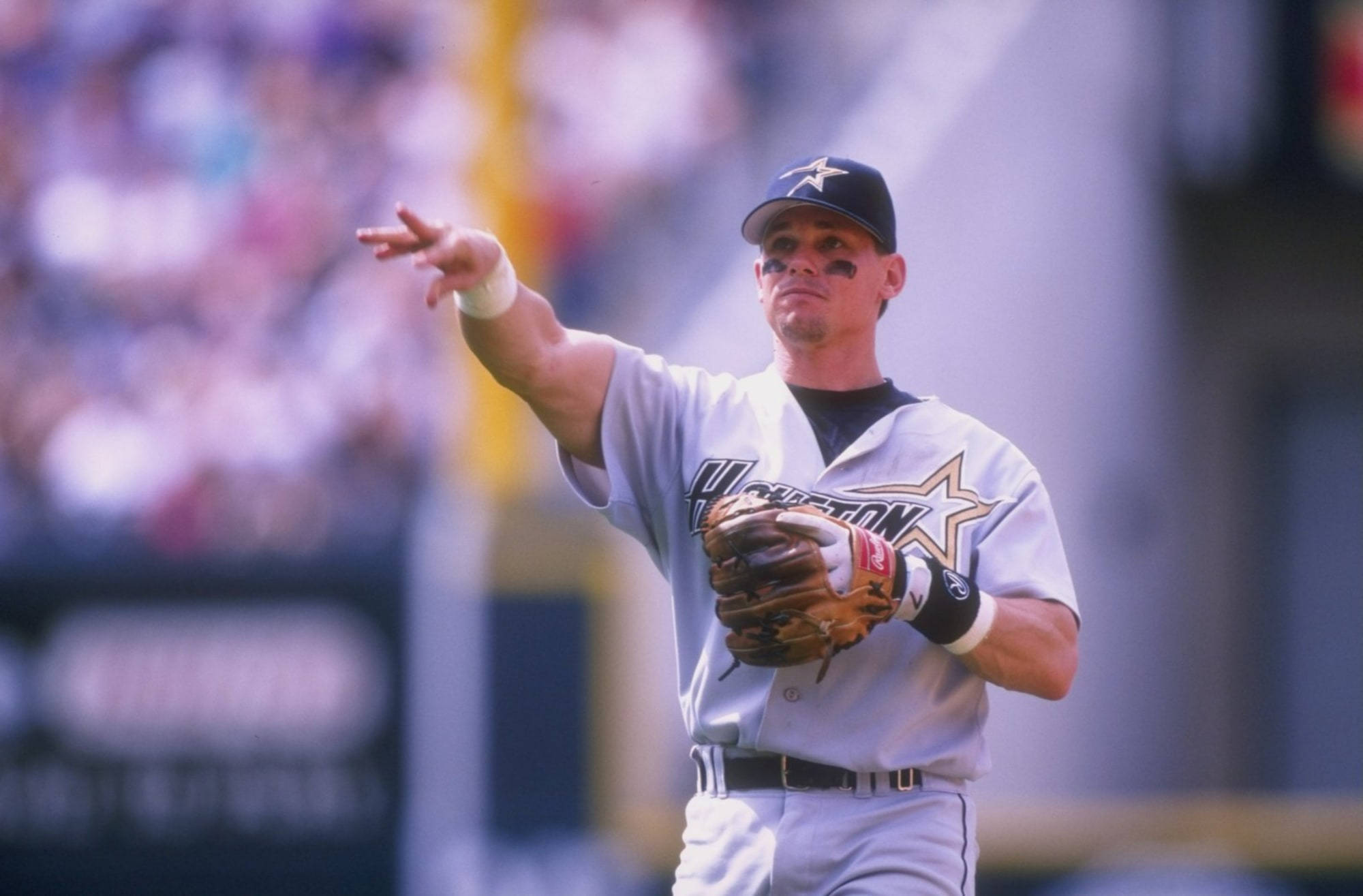 Craig Biggio 桌布 壁紙 — 一名身穿休士頓太空人隊球衣的棒球選手，在日間比賽中右手做手勢，左手前臂戴著手套。