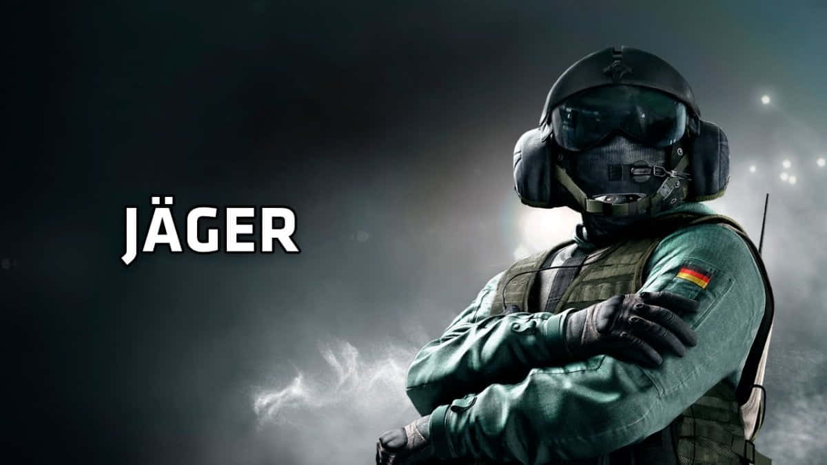 Rainbow Six Siege Jager 桌布 壁紙 — 一名身穿全套戰術裝備的士兵自信地交叉雙臂，站在煙霧瀰漫的黑暗背景前，顯示著「JÄGER」字樣。