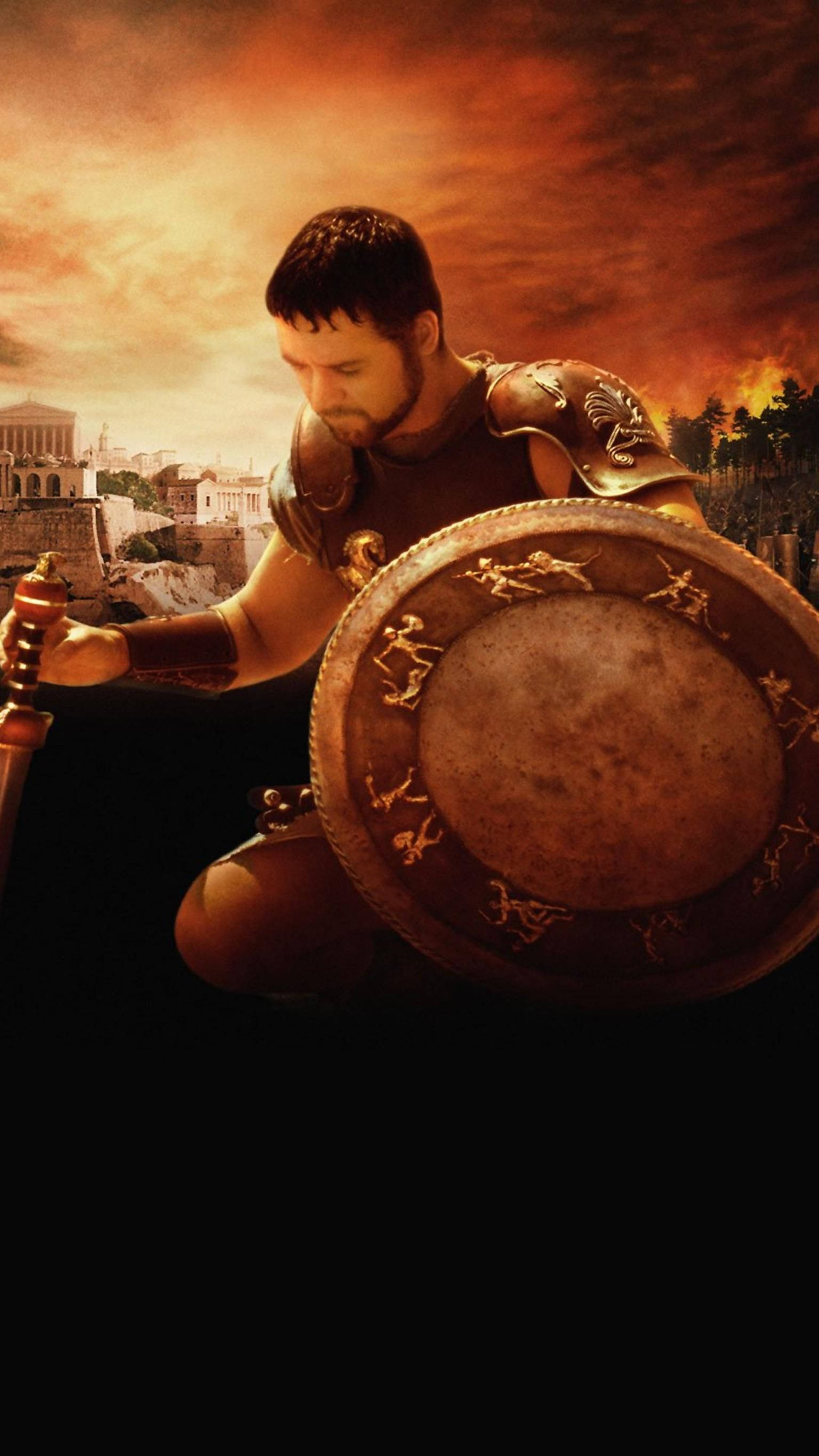 Gladiator 桌布 壁紙 — 一名身穿古代盔甲的戰士，在廢墟城市上空火紅的橙色日落中，手持精緻的盾牌和劍。