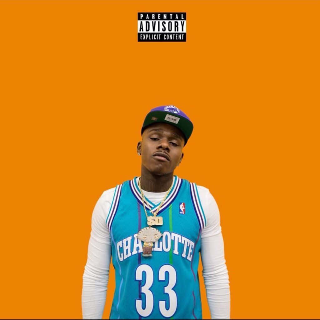 Dababy Cartoon 桌布 壁紙 — 一名身穿夏洛特黃蜂隊球衣和帽子的男子在純橙色背景和家長指引標籤前自信地凝視。