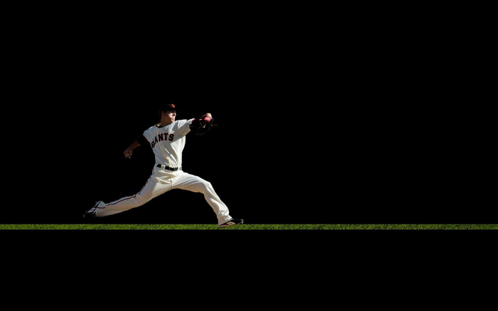 Baseball Players 桌布 壁紙 — 一名身穿巨人隊球衣的棒球投手在純黑色背景和一條細長的綠色草地線上投球。