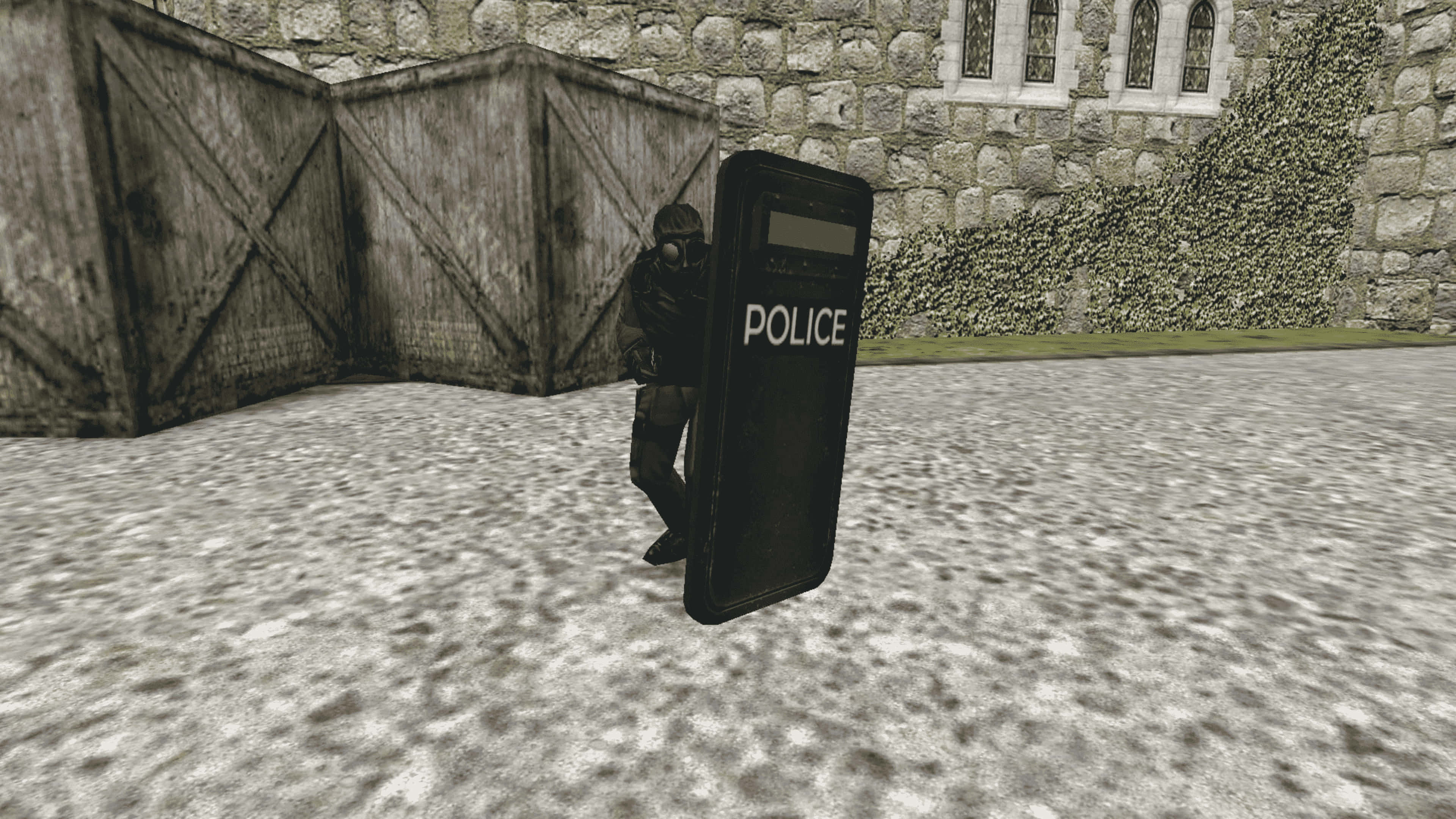 game 桌布 壁紙 — 一名身穿戰術裝備的警察手持一個印有警察字樣的大型黑色盾牌，站在石牆和木製路障前。