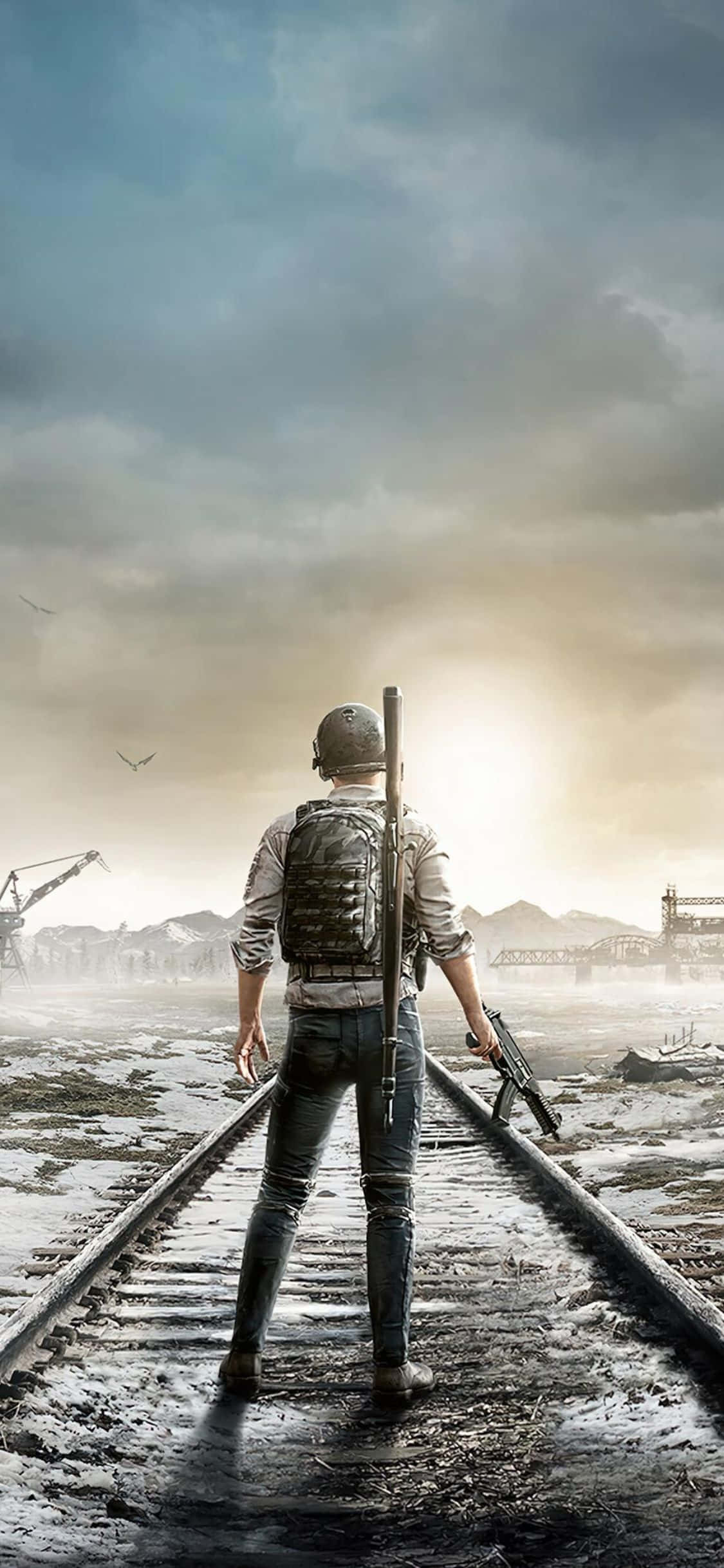 iPhone X Metro Exodus 桌布 壁紙 — 一名身穿戰鬥裝備的士兵獨自站在濕漉漉的火車軌道上，凝視著陰天下一片遙遠的工業廢墟。