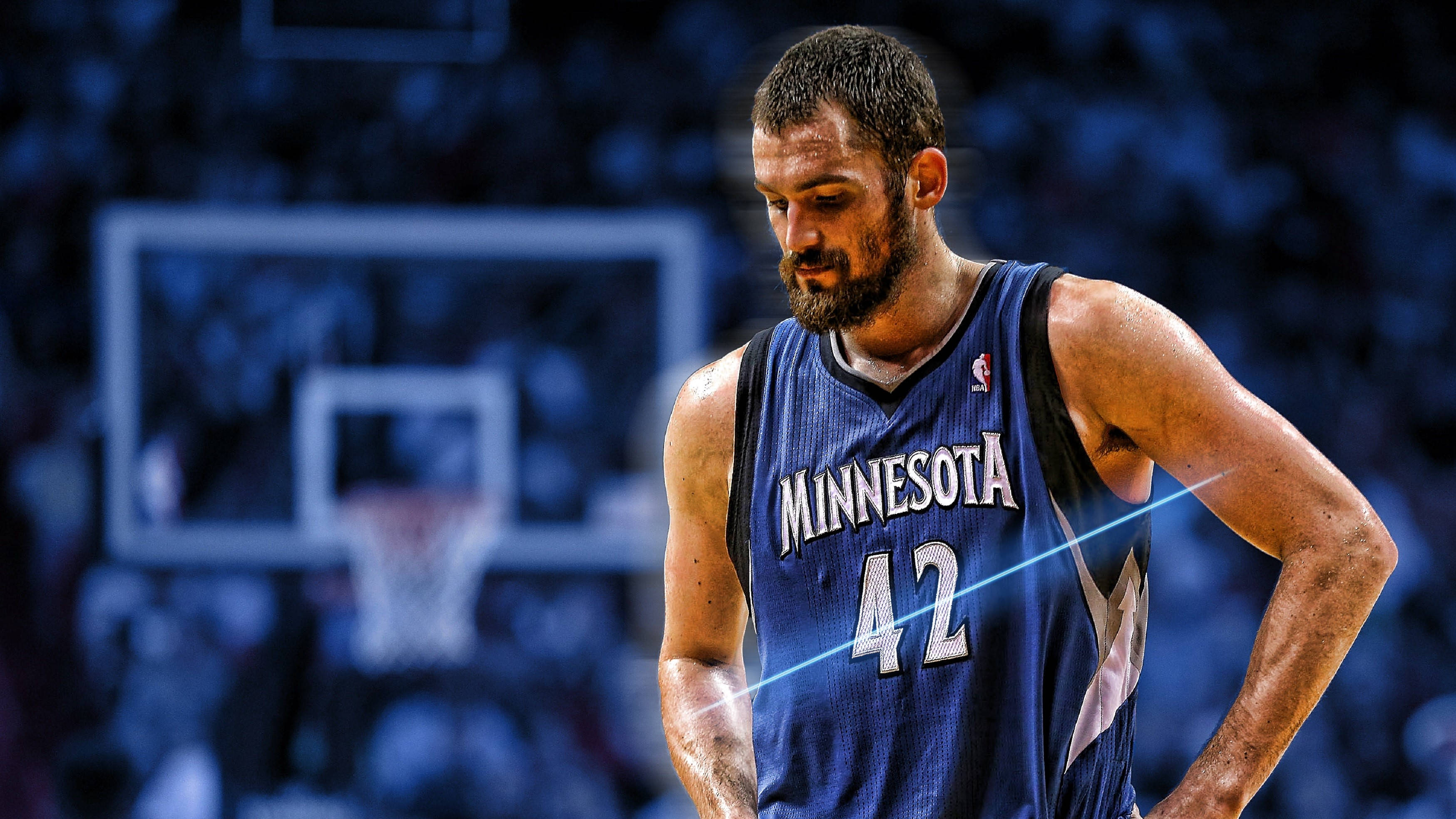 Kevin Love 桌布 壁紙 — 一名身穿明尼蘇達球衣的籃球運動員在昏暗的場館中雙手叉腰低頭站立。