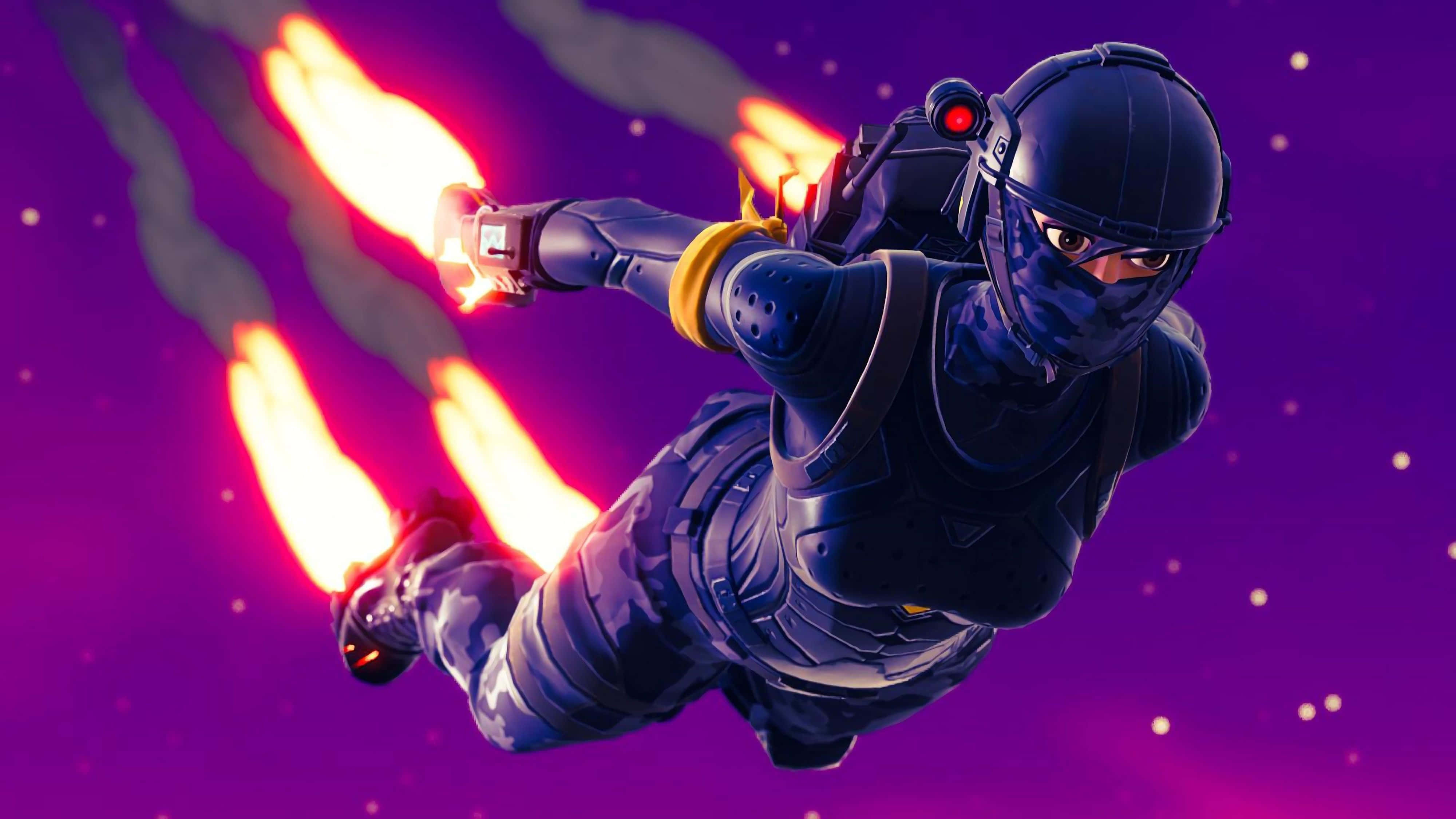 Fortnite 桌布 壁紙 — 一名身穿暗色盔甲的未來士兵，在佈滿星星的紫色天空中翱翔，由熾熱的噴氣背包推進器推動。