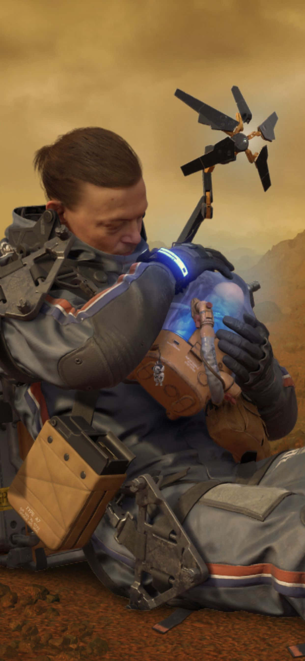 iPhone Xs Max Death Stranding 桌布 壁紙 — 一名身穿未來盔甲的士兵跪在外星土地上，懷抱著一個發光的藍色機械夥伴，背景是朦朧的橙色天空。