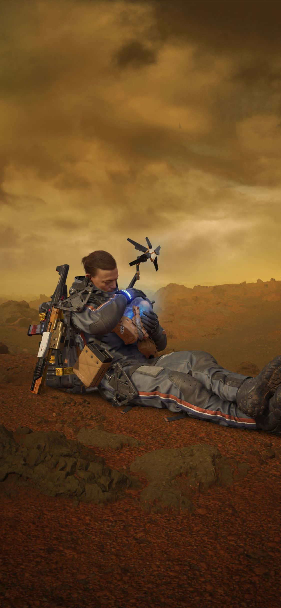 iPhone X Death Stranding 桌布 壁紙 — 一名身穿未來裝甲的士兵在荒涼的外星行星上，在暴風雨的橙色天空下擁抱一個孩子。