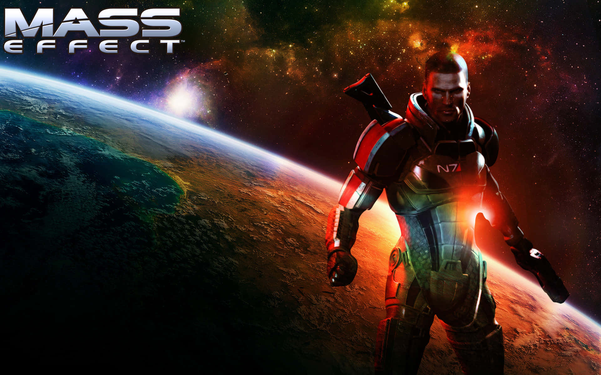 Mass Effect 2 桌布 壁紙 — 一名身穿未來裝甲的士兵站在發光行星前，背景是星光宇宙，並有Mass Effect標誌。