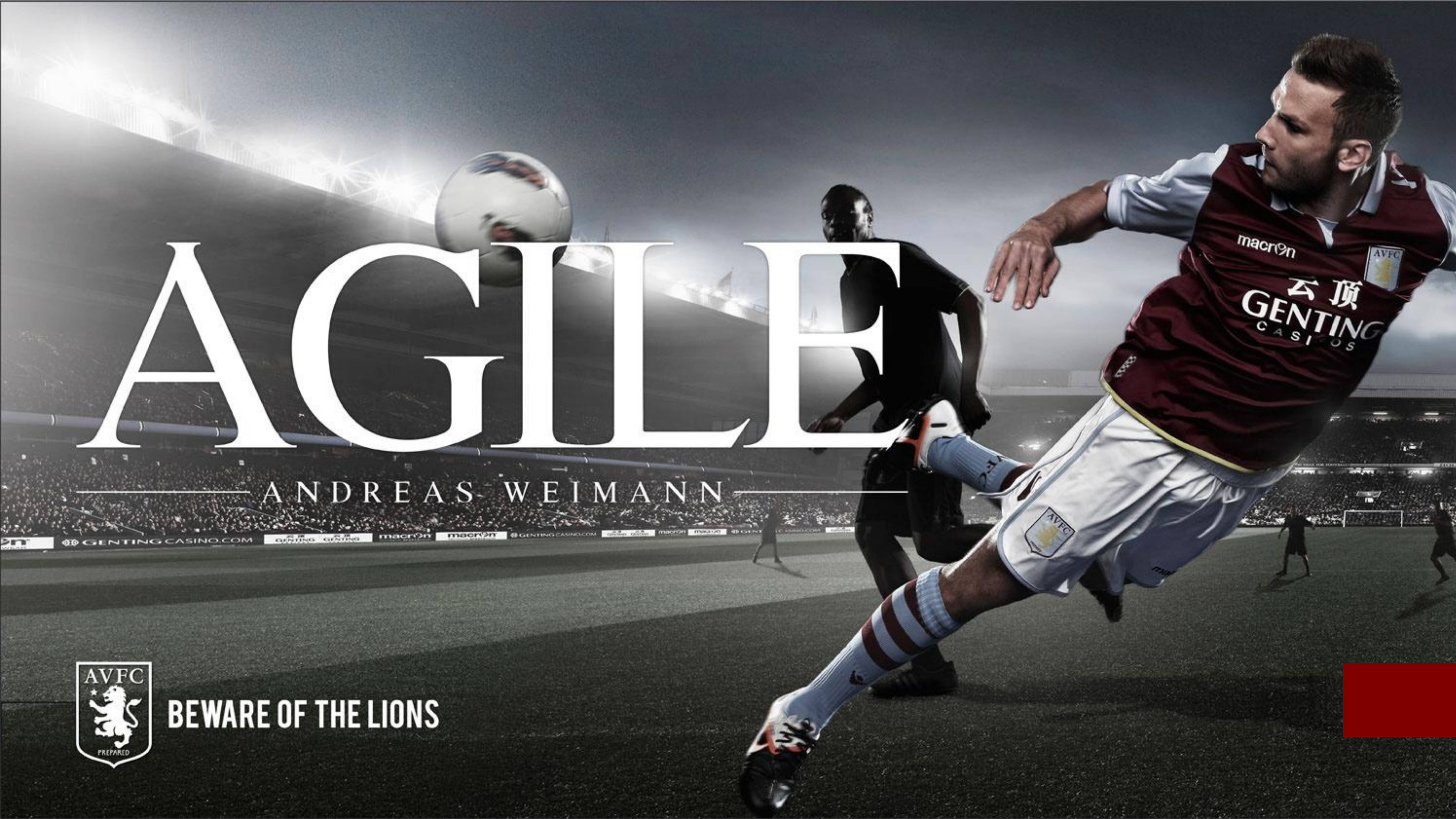 Villa 桌布 壁紙 — 一名身穿栗色球衣的足球員在戲劇性的球場聚光燈場景中跳起頭球。