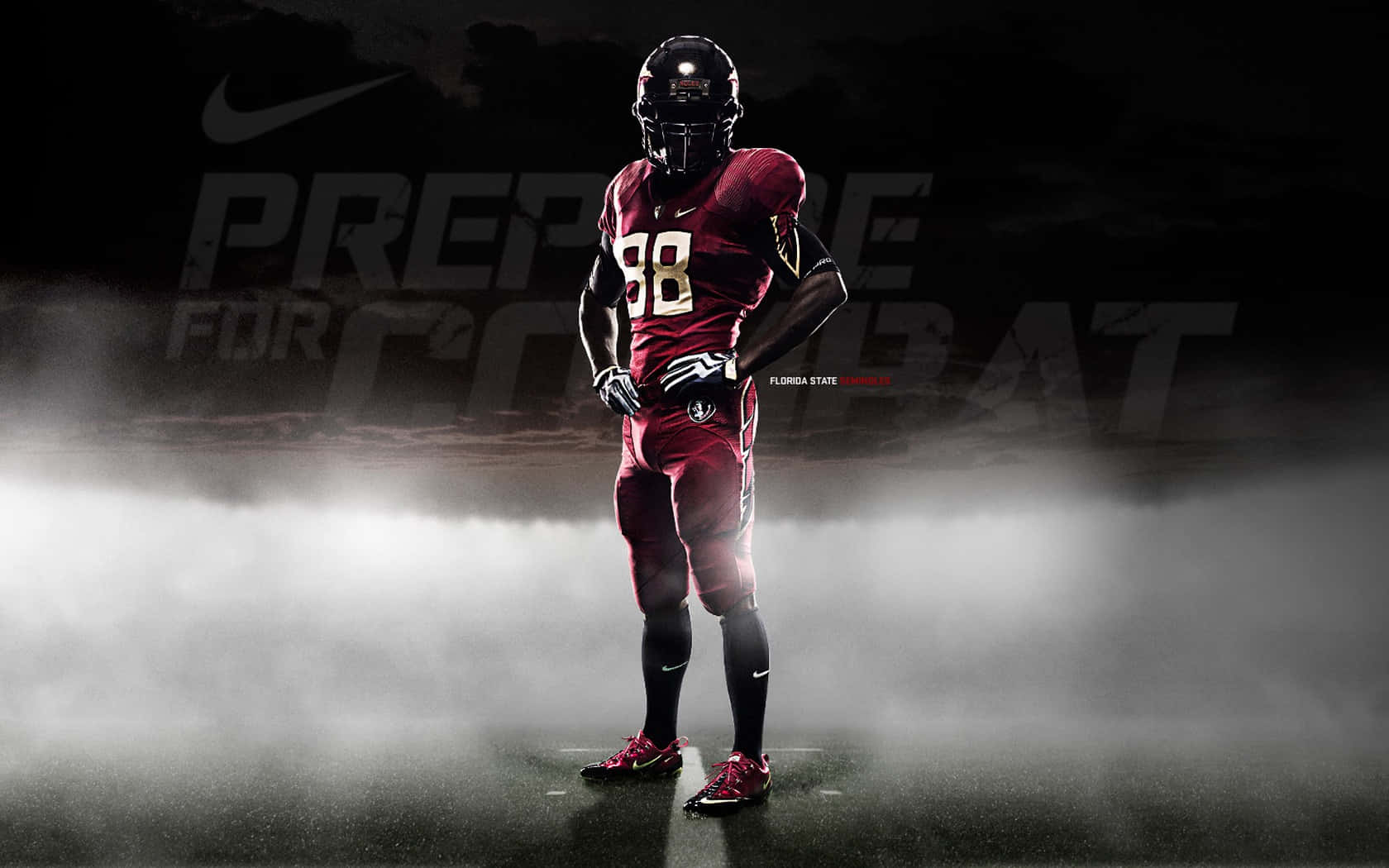 Nike 桌布 壁紙 — 一名身穿栗色球衣的足球員在迷霧中蓄勢待發，身後有「Prepare for Combat」字樣。