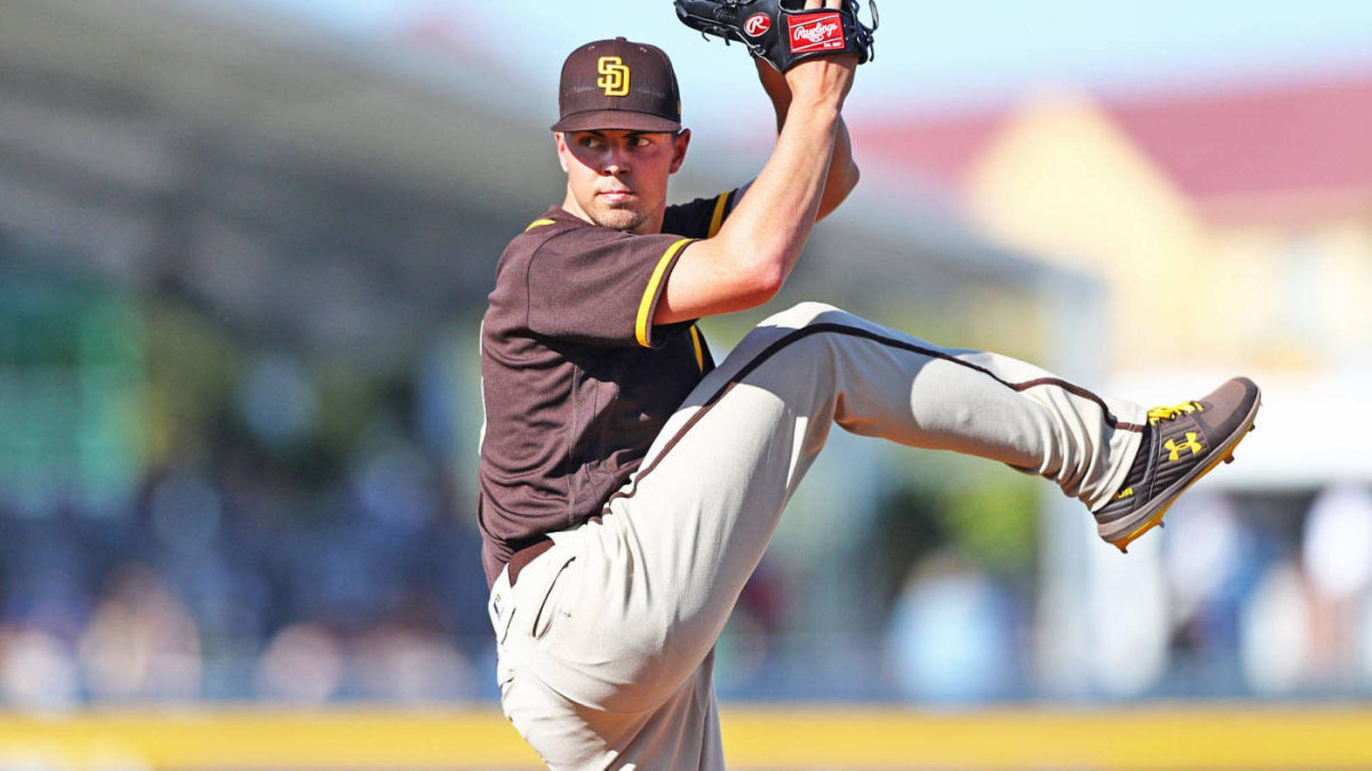 Padres 桌布 壁紙 — 一名身穿棕色和金色球衣的棒球投手，在明亮的日光下以高度專注力投出強力一球。