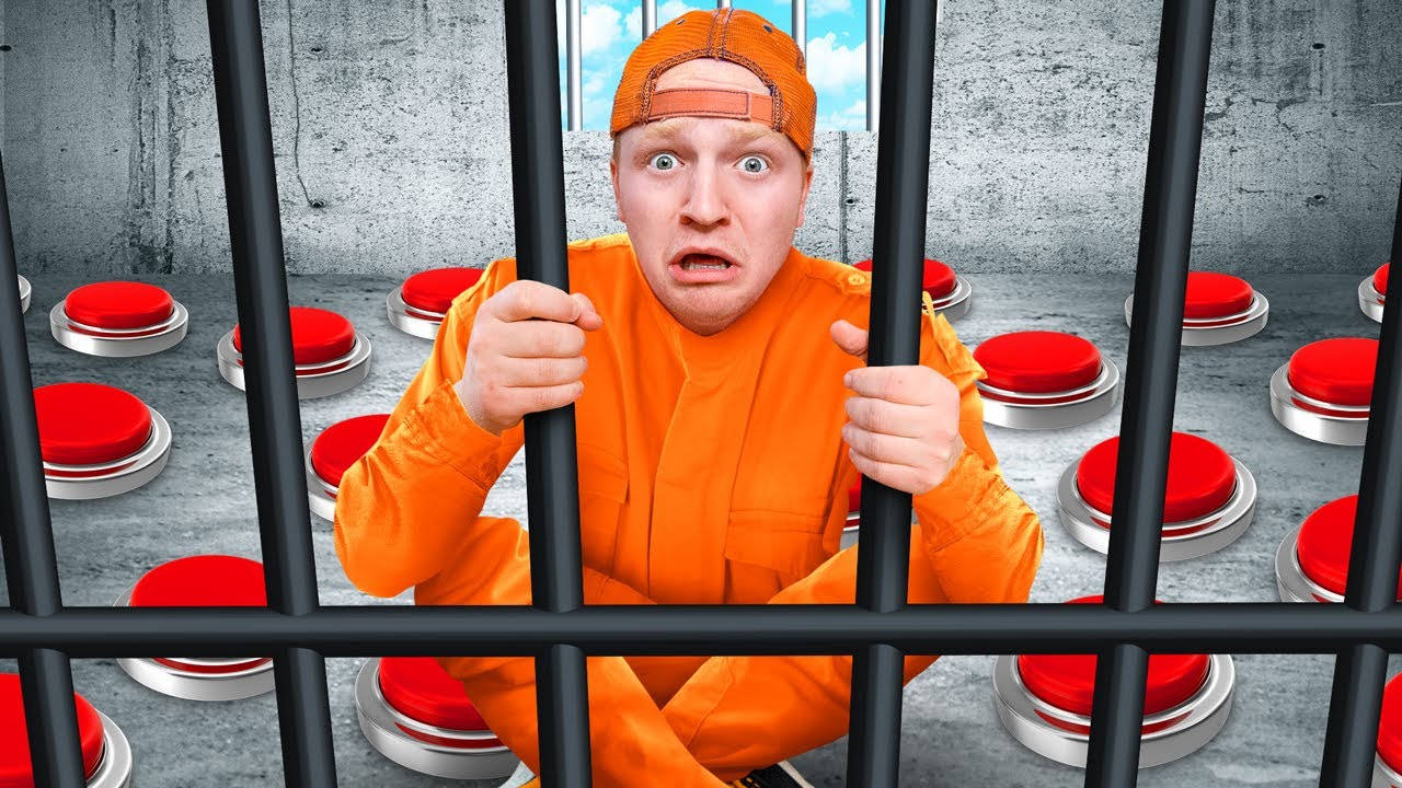 Unspeakable 桌布 壁紙 — 一名身穿橙色囚衣的男子在監獄鐵欄後被紅色按鈕包圍，神情驚恐。