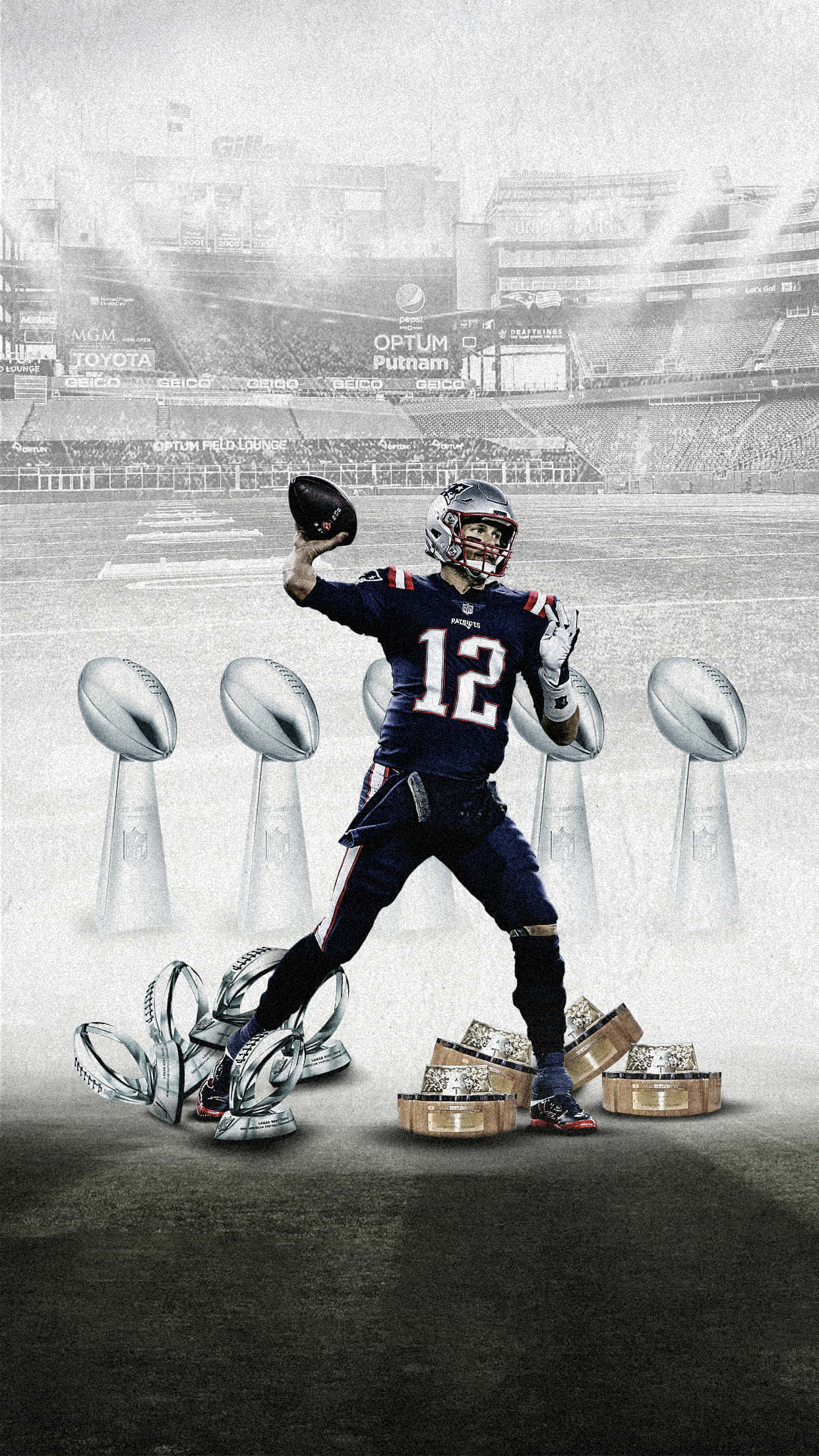 Super Bowl 桌布 壁紙 — 一名身穿海軍藍球衣、號碼12的美式足球運動員，在場上被多個超級碗獎盃環繞，勝利地站立著。