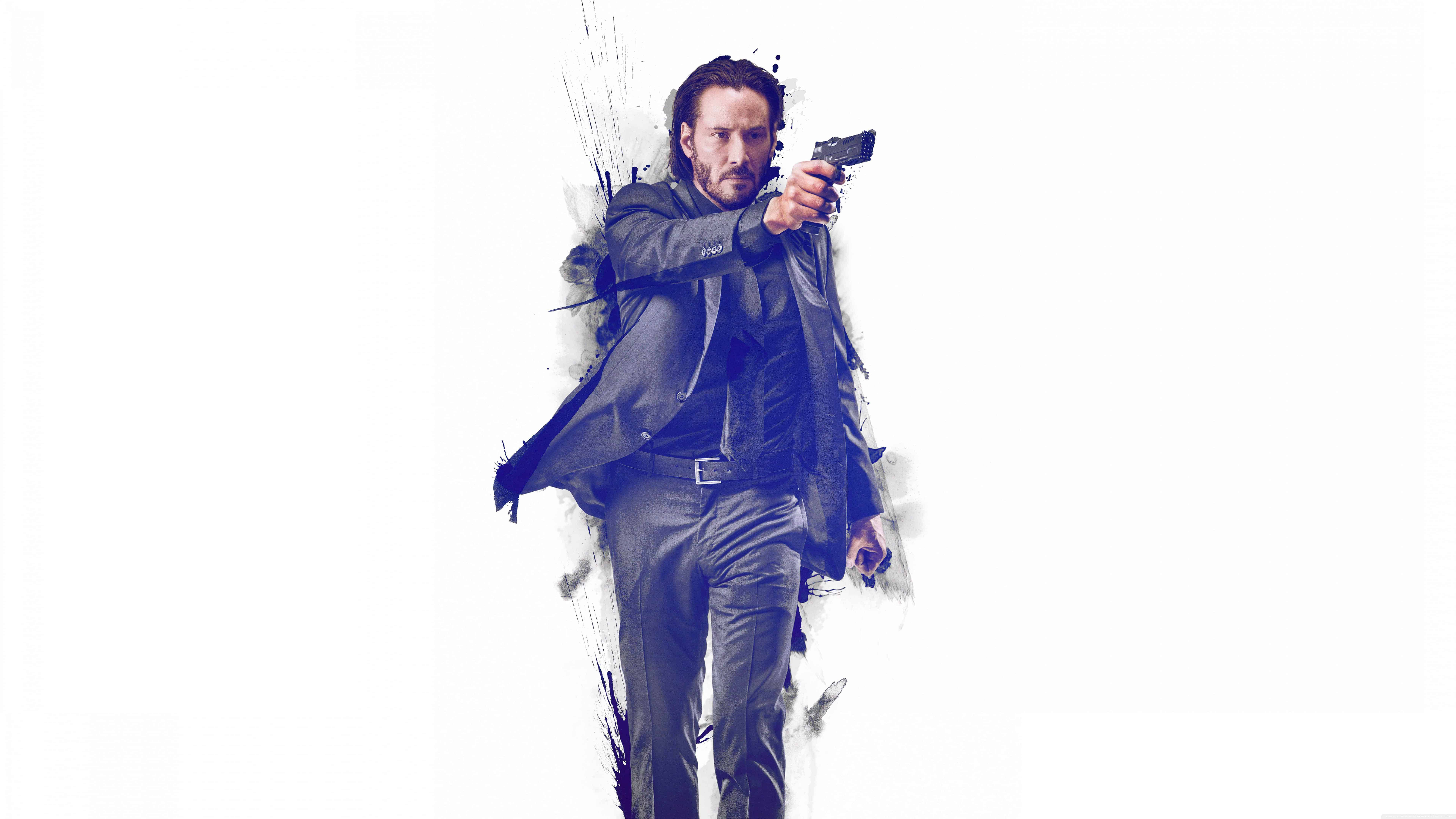 John Wick 桌布 壁紙 — 一名身穿深色西裝的男子在純白色背景上，帶有墨水飛濺效果，專注地瞄準手槍。