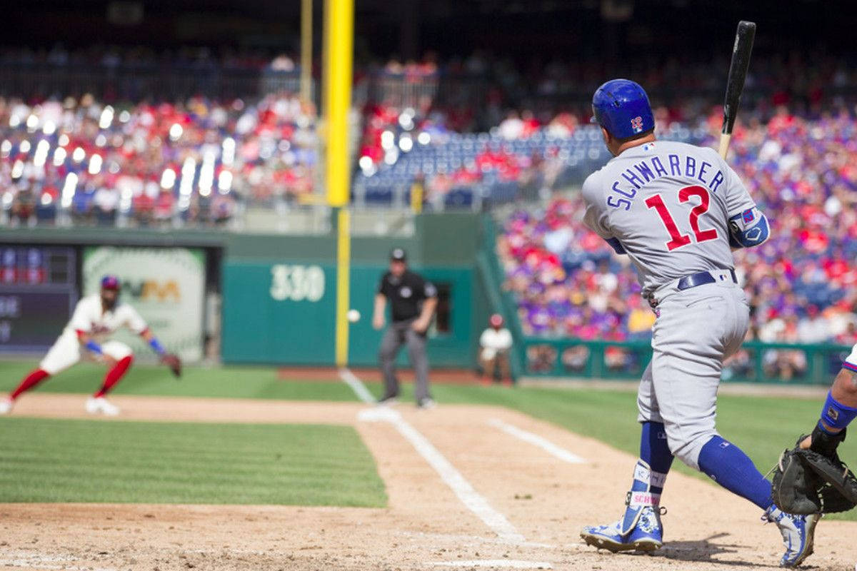 MLB 桌布 壁紙 — 一名身穿灰色球衣、背號12的棒球選手在夜間比賽中，於球場燈光下揮棒擊球。