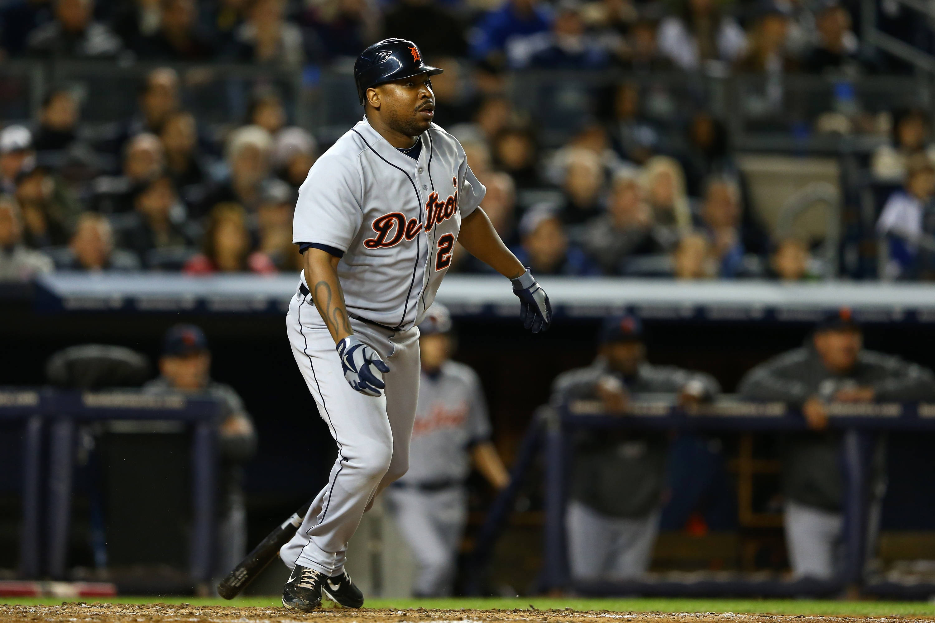 tigers 桌布 壁紙 — 一名身穿灰色球衣的底特律老虎隊棒球選手在球場燈光下擊出全壘打後，正全力衝向一壘。
