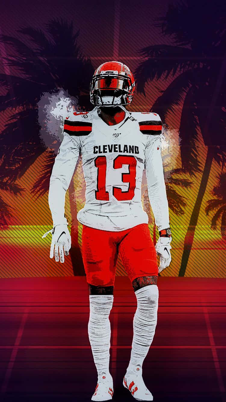 Obj 桌布 壁紙 — 一名身穿白色和紅色球衣的克里夫蘭足球員，在棕櫚樹襯托的鮮豔日落背景下自信地站立。