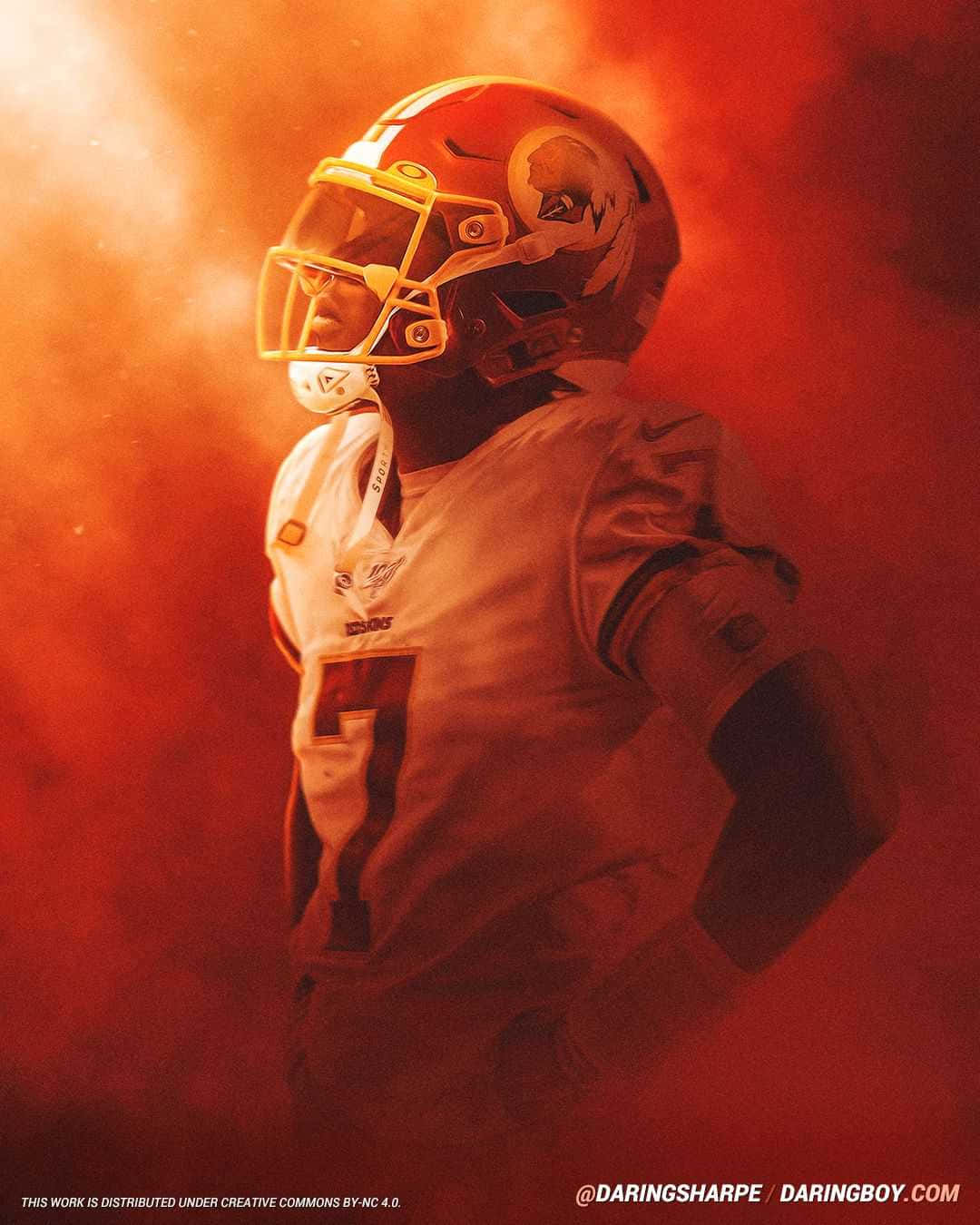 Dwayne Haskins 桌布 壁紙 — 一名身穿白色球衣和紅色頭盔的美式足球員，在強烈的橙色煙霧和戲劇性燈光中站立。