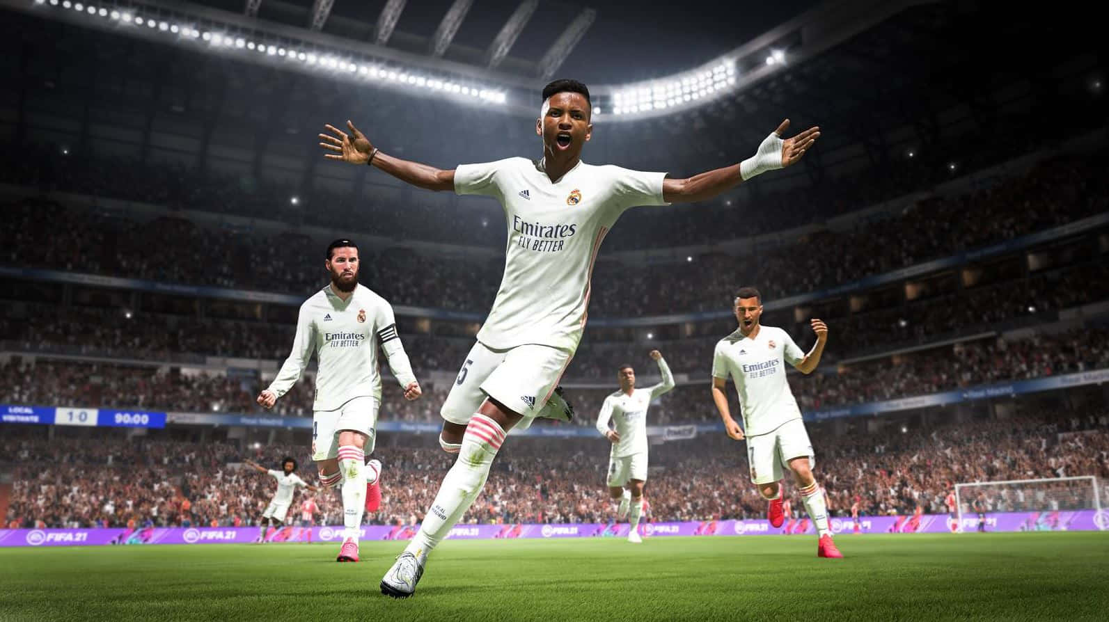 Fifa 22 桌布 壁紙 — 一名身穿白色球衣的足球運動員在燈火通明的球場上張開雙臂，勝利地慶祝。