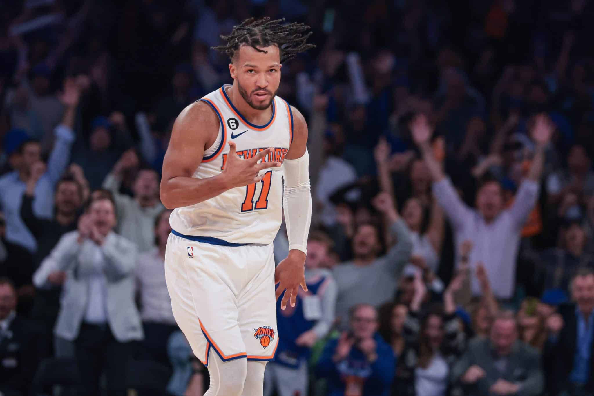 NBA 桌布 壁紙 — 一名身穿白色紐約尼克隊11號球衣的籃球運動員在球場上慶祝，背景中球迷歡呼。