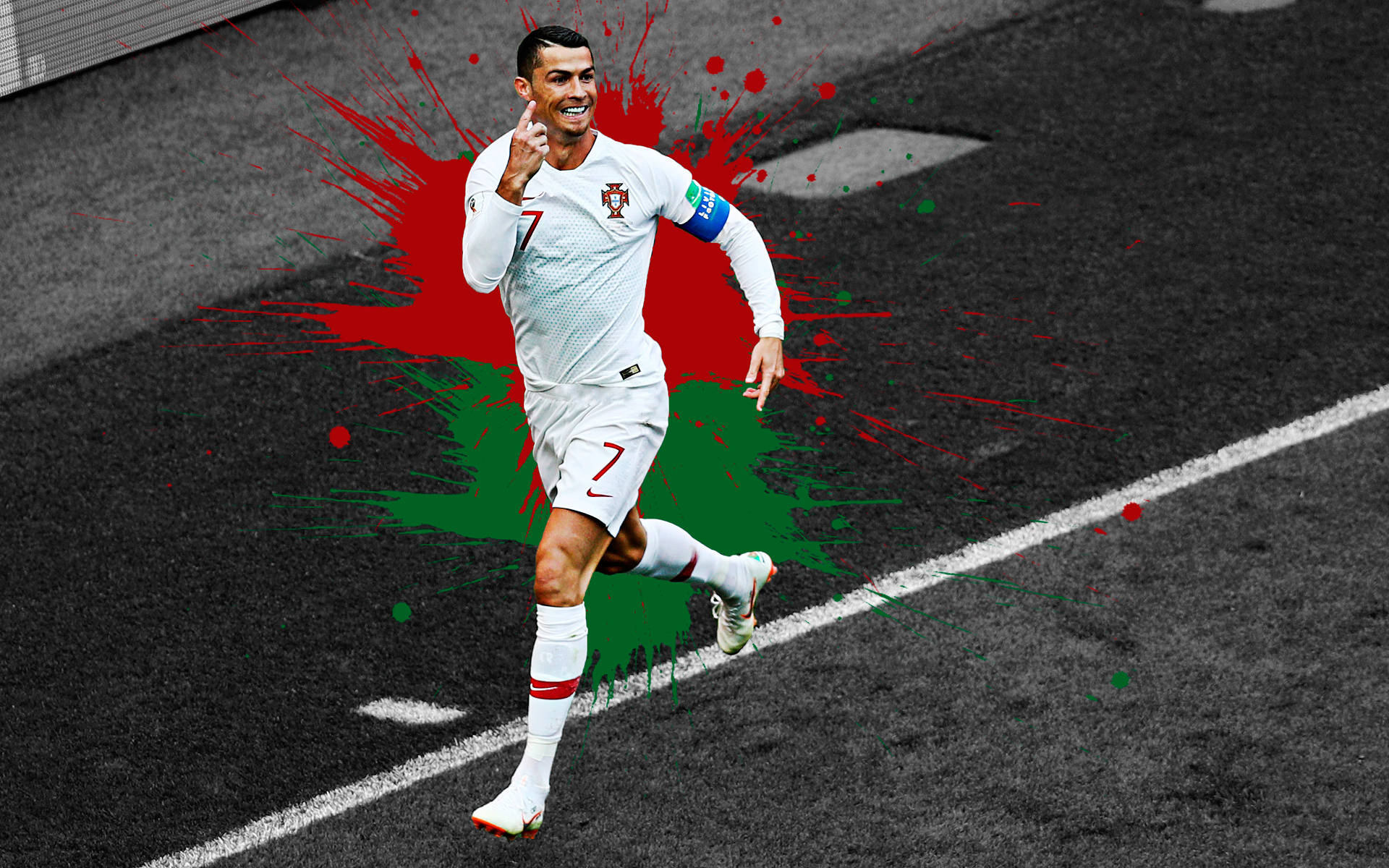 Ronaldo 桌布 壁紙 — 一名身穿白色葡萄牙球衣的足球員在黑色瀝青場地上快樂地奔跑，身後有紅色和綠色的油漆飛濺。
