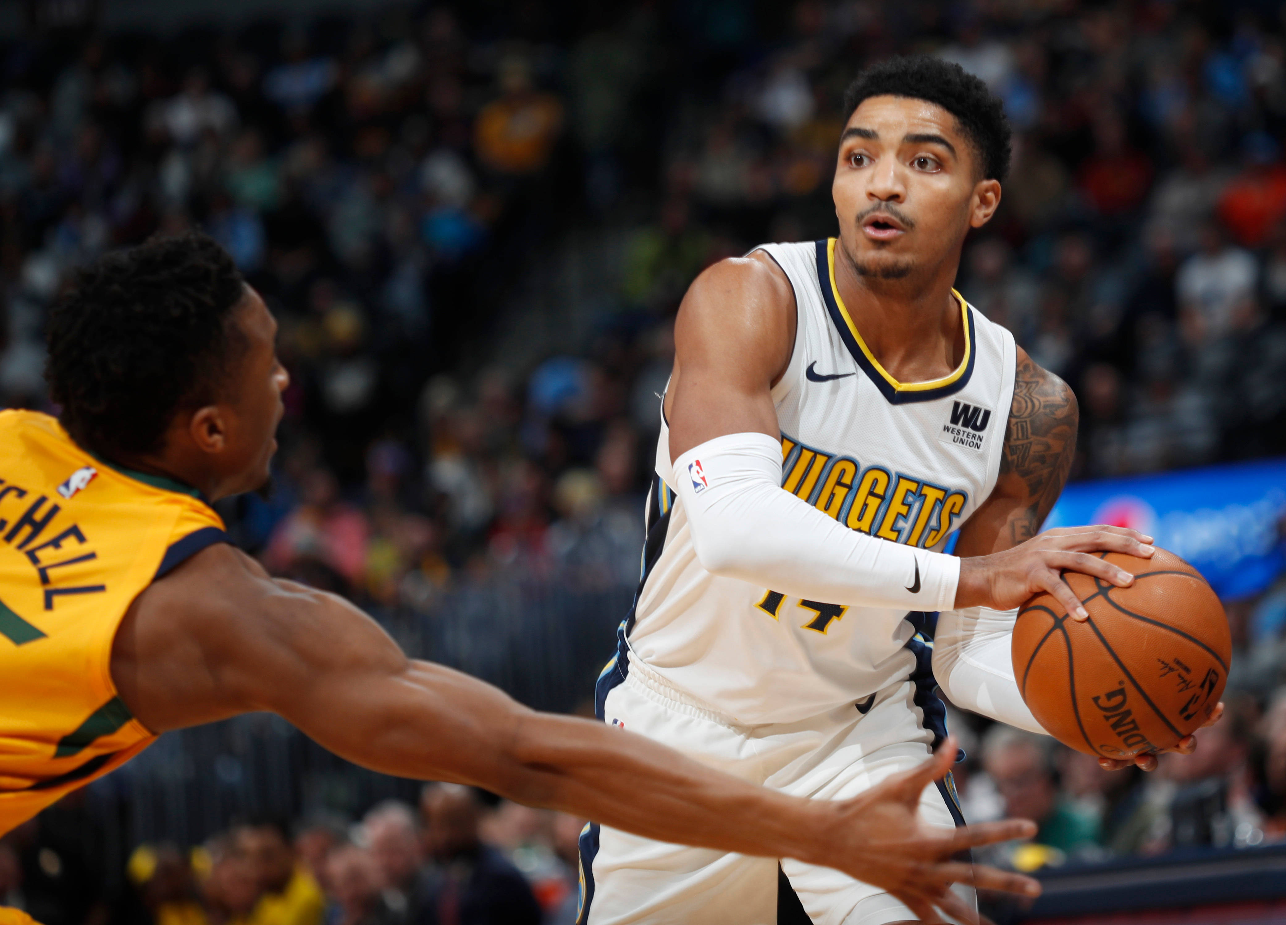 gary harris 桌布 壁紙 — 一名身穿白色金塊球衣的籃球運動員在激烈的比賽中帶球越過身穿黃色球衣的防守球員。