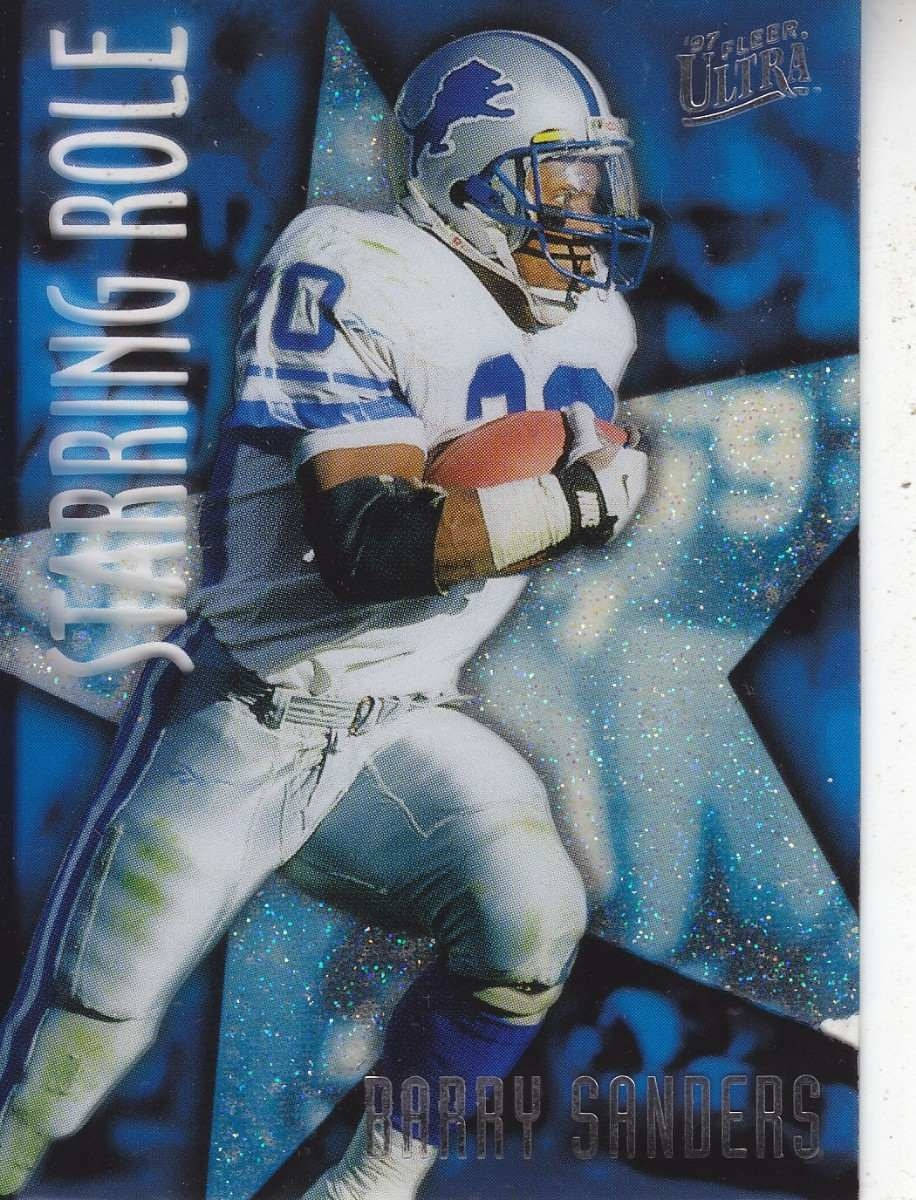 Barry Sanders 桌布 壁紙 — 一名身穿白藍色球衣的動感美式足球員，手持美式足球，在閃爍的藍色星星背景前向前衝刺。