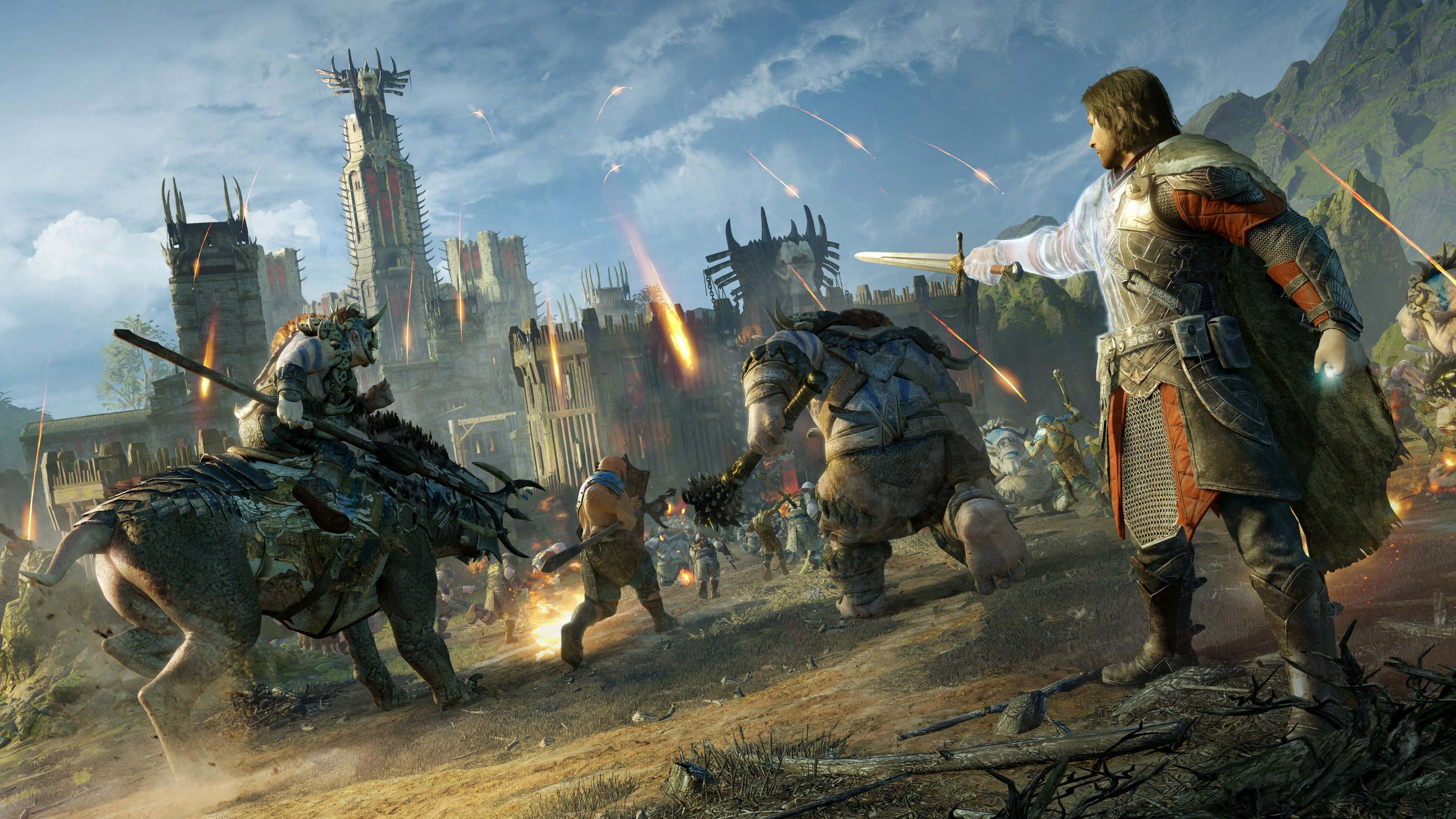 4K Shadow Of War 桌布 壁紙 — 一名身穿盔甲的戰士在陰雲密布的天空下，於燃燒的堡壘前的混亂戰場上斬殺怪物般的敵人。