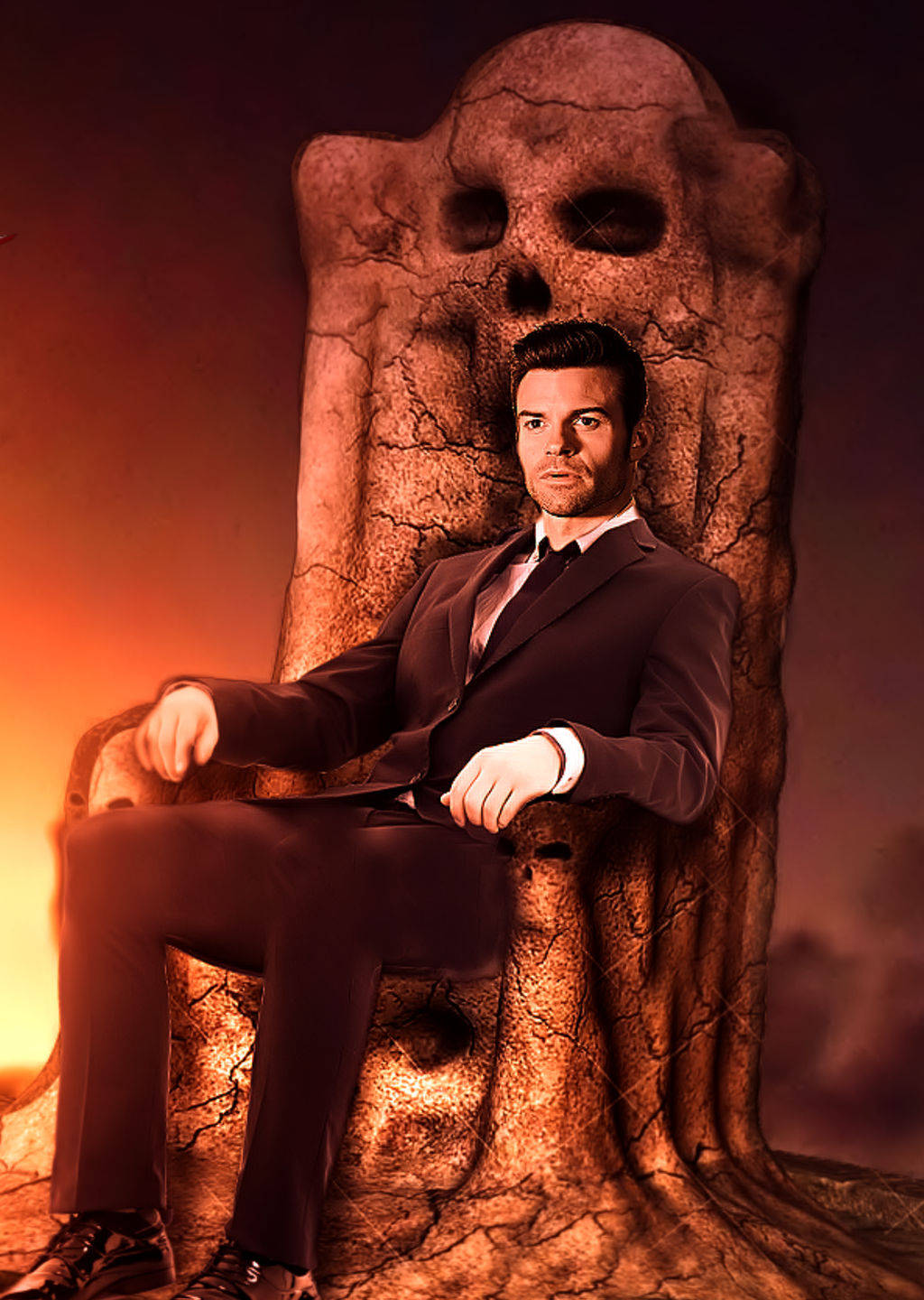 elijah mikaelson 桌布 壁紙 — 一名身穿筆挺西裝的男子，威嚴地坐在一個由巨大頭骨雕刻而成的王座上，背景是火紅的橙色。
