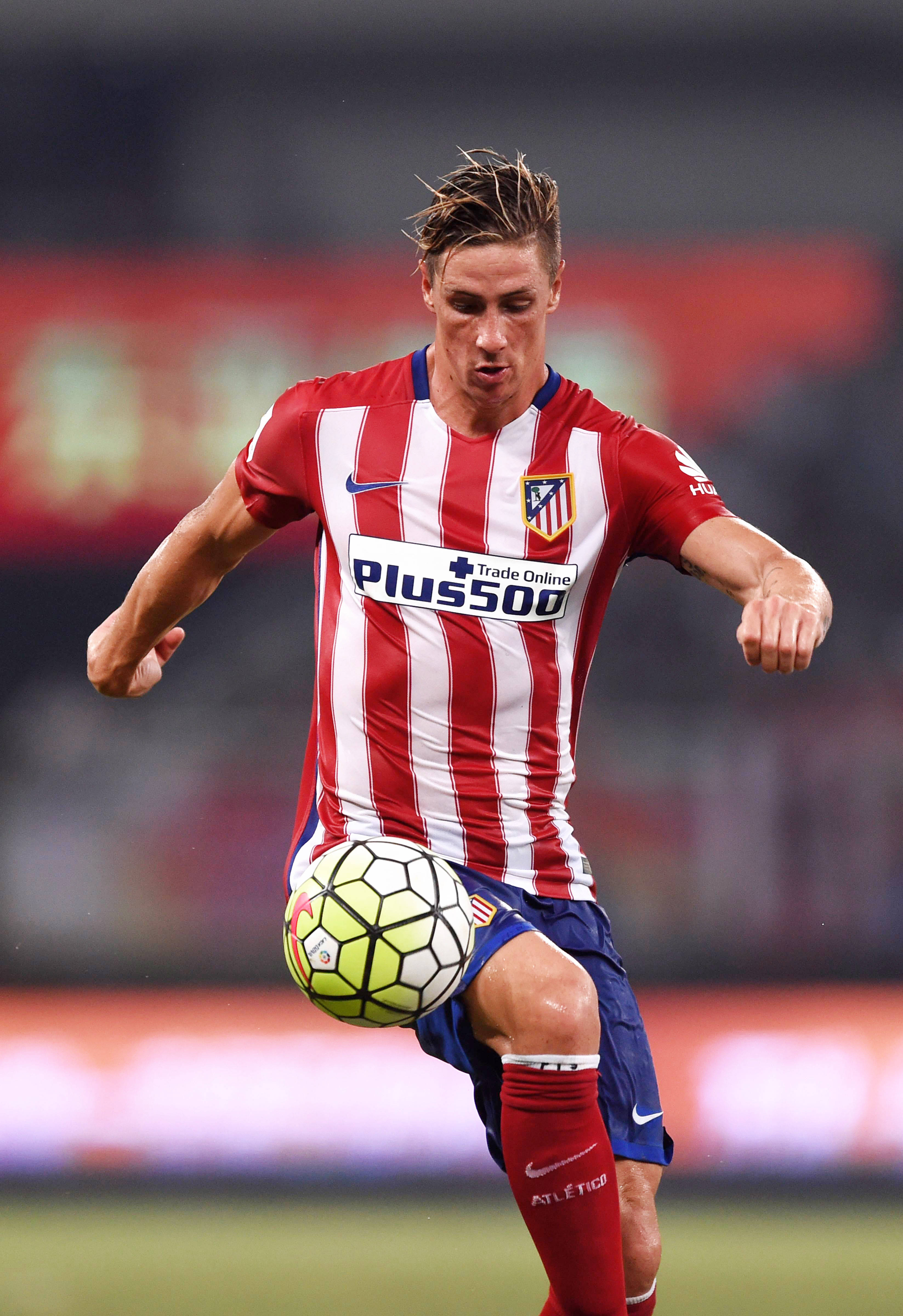 Torres 桌布 壁紙 — 一名身穿紅白條紋的足球運動員在球場上控制著黃色足球，動作激烈。