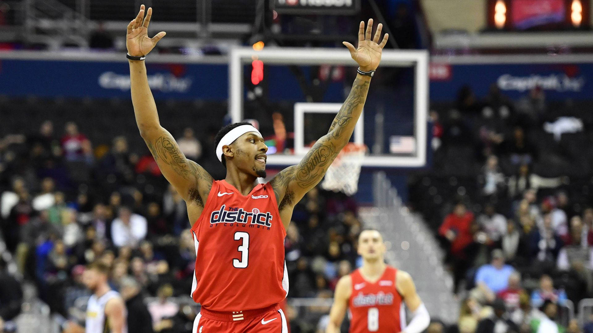 Bradley Beal 桌布 壁紙 — 一名身穿紅色District球衣、背號3的籃球運動員在室內比賽中高舉雙臂慶祝，背景有觀眾。