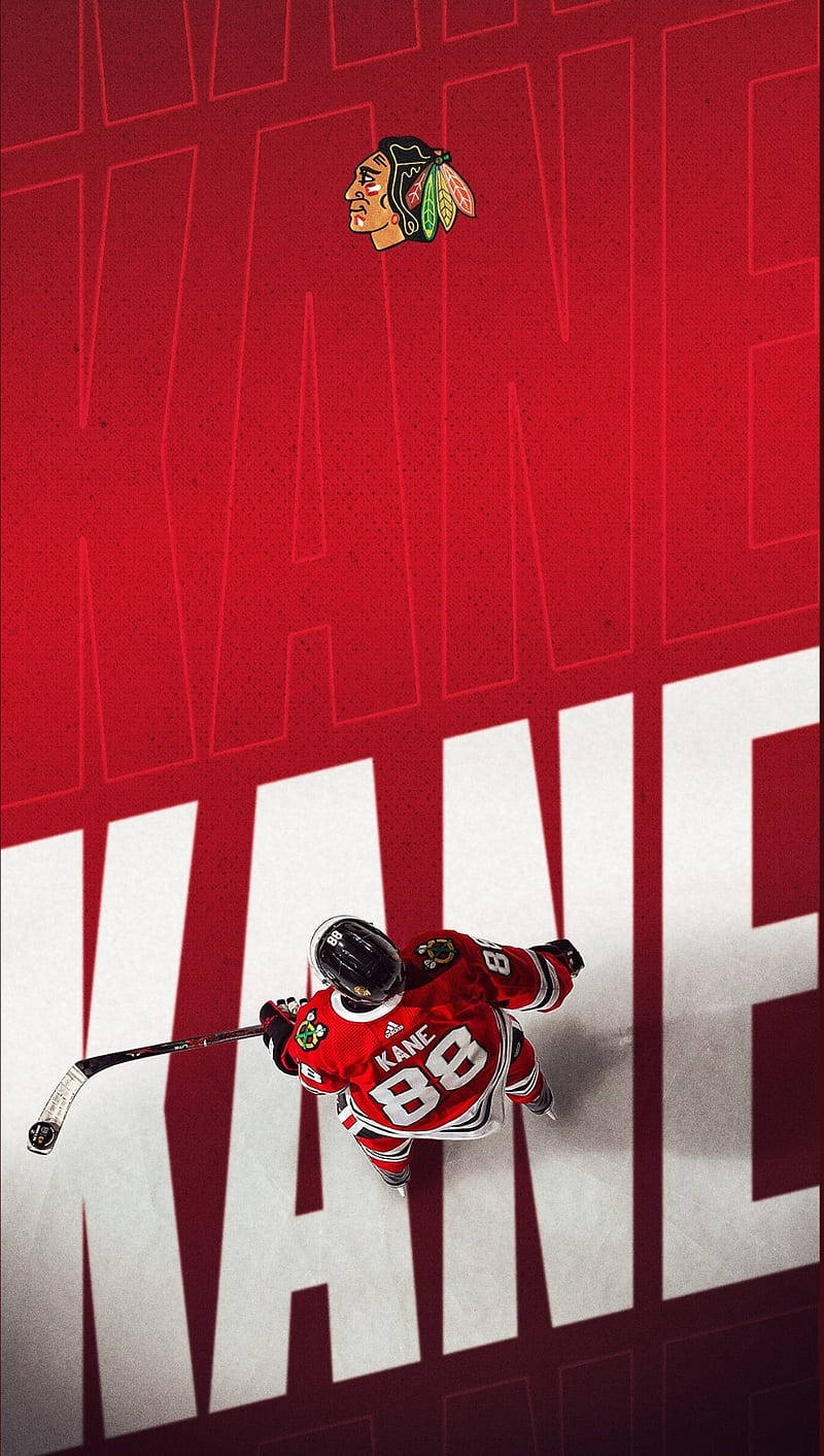 Blackhawks 桌布 壁紙 — 一名身穿紅色球衣、號碼88的冰上曲棍球運動員站在冰面上，下方是巨大的白色字母KANE，背景為大膽的紅色。