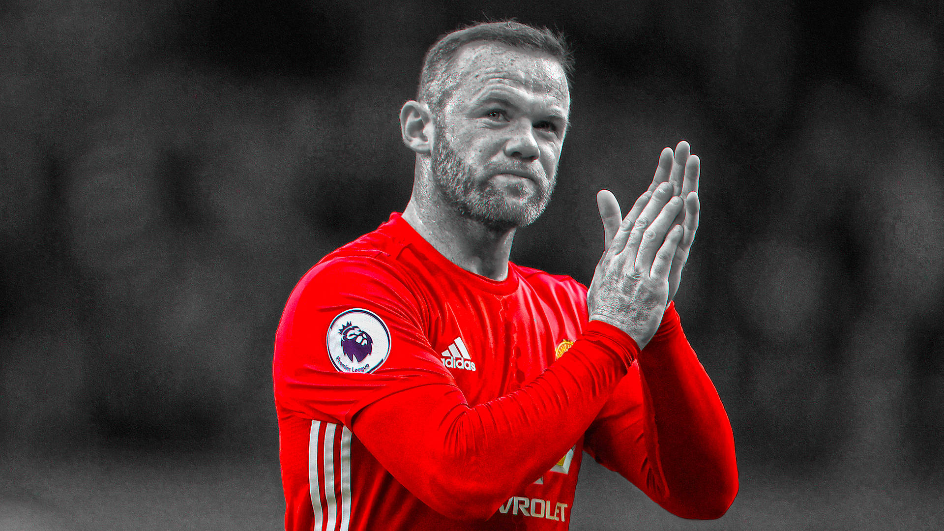 Rooney 桌布 壁紙 — 一名身穿紅色球衣的足球運動員，在模糊的黑白背景下，專注地拍手。