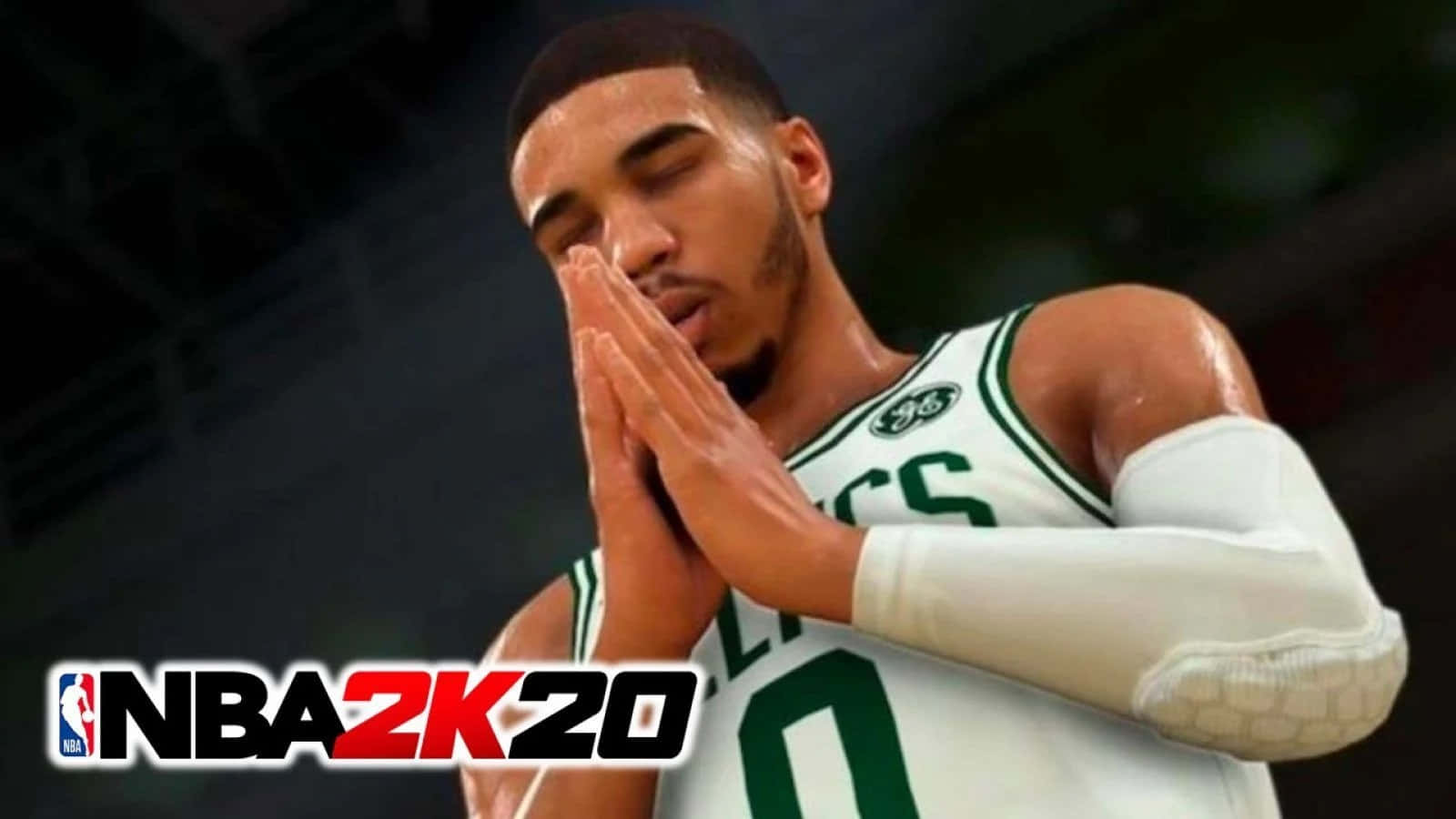 NBA 2k20 桌布 壁紙 — 一名身穿綠色和白色塞爾提克球衣的籃球運動員在比賽中雙手合十祈禱或集中精神。