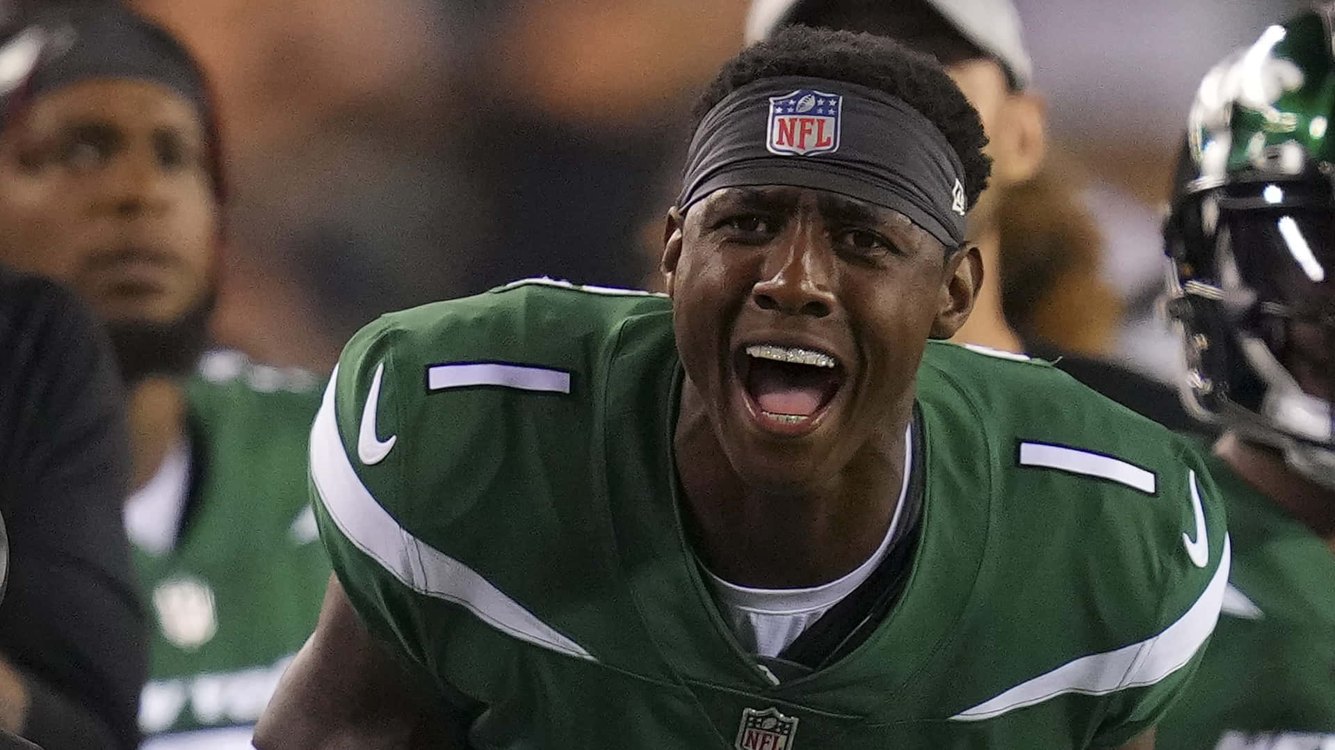 身穿綠色球衣的足球運動員在比賽中尖叫。 — NFL GIF 壁紙