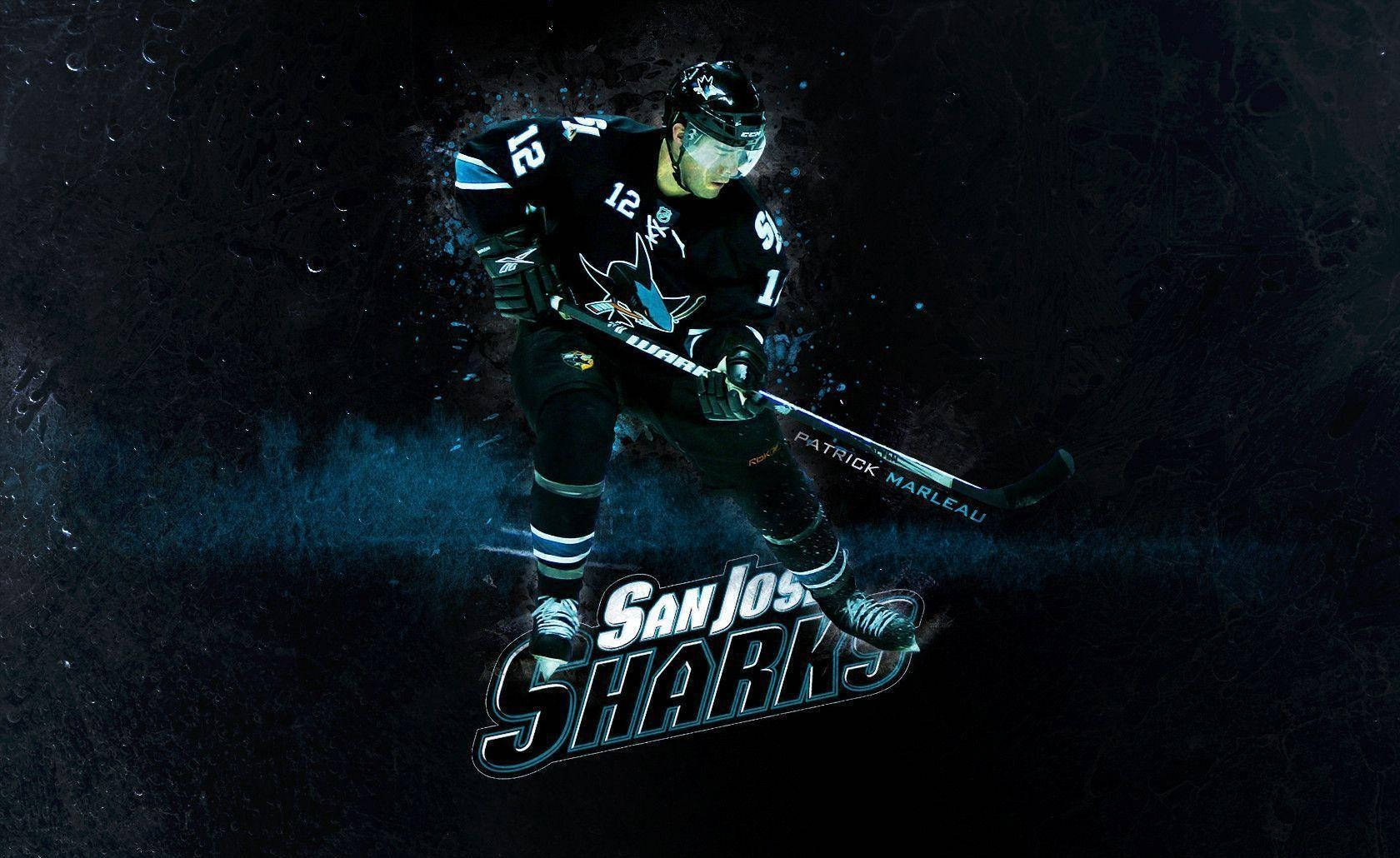 sharks 桌布 壁紙 — 一名身穿聖荷西鯊魚隊黑色12號球衣的冰球運動員，在帶有藍色燈光效果的深色紋理背景前向前滑行。